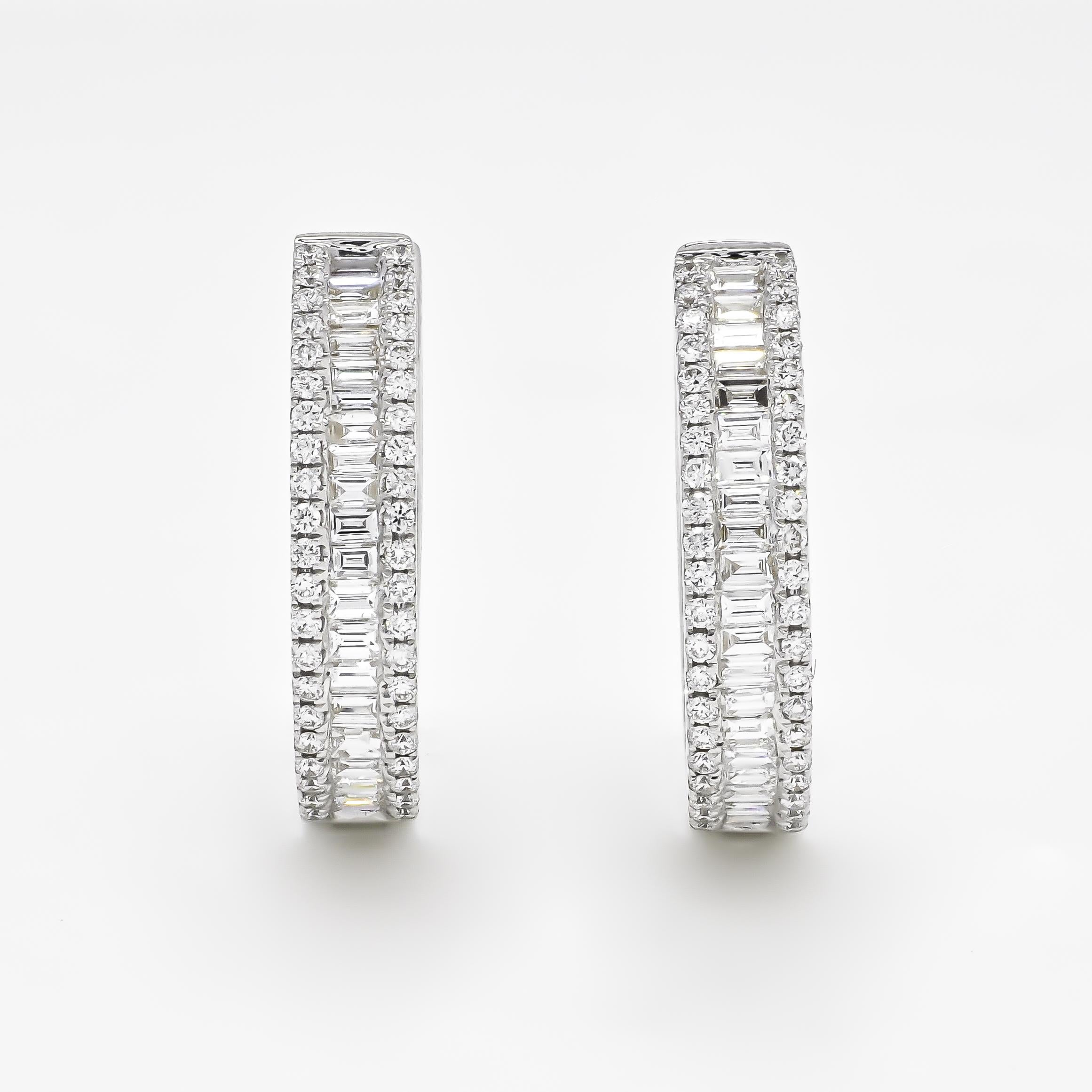 An Elegant 18 KT  Hoop earring gives a dainty look! 

Take her breath away with the bold baguette shine of these exquisite hoop earrings bordered by the gorgeous shimmer of round-shape accent diamonds. Accessorize with elegance. These stunning hoop