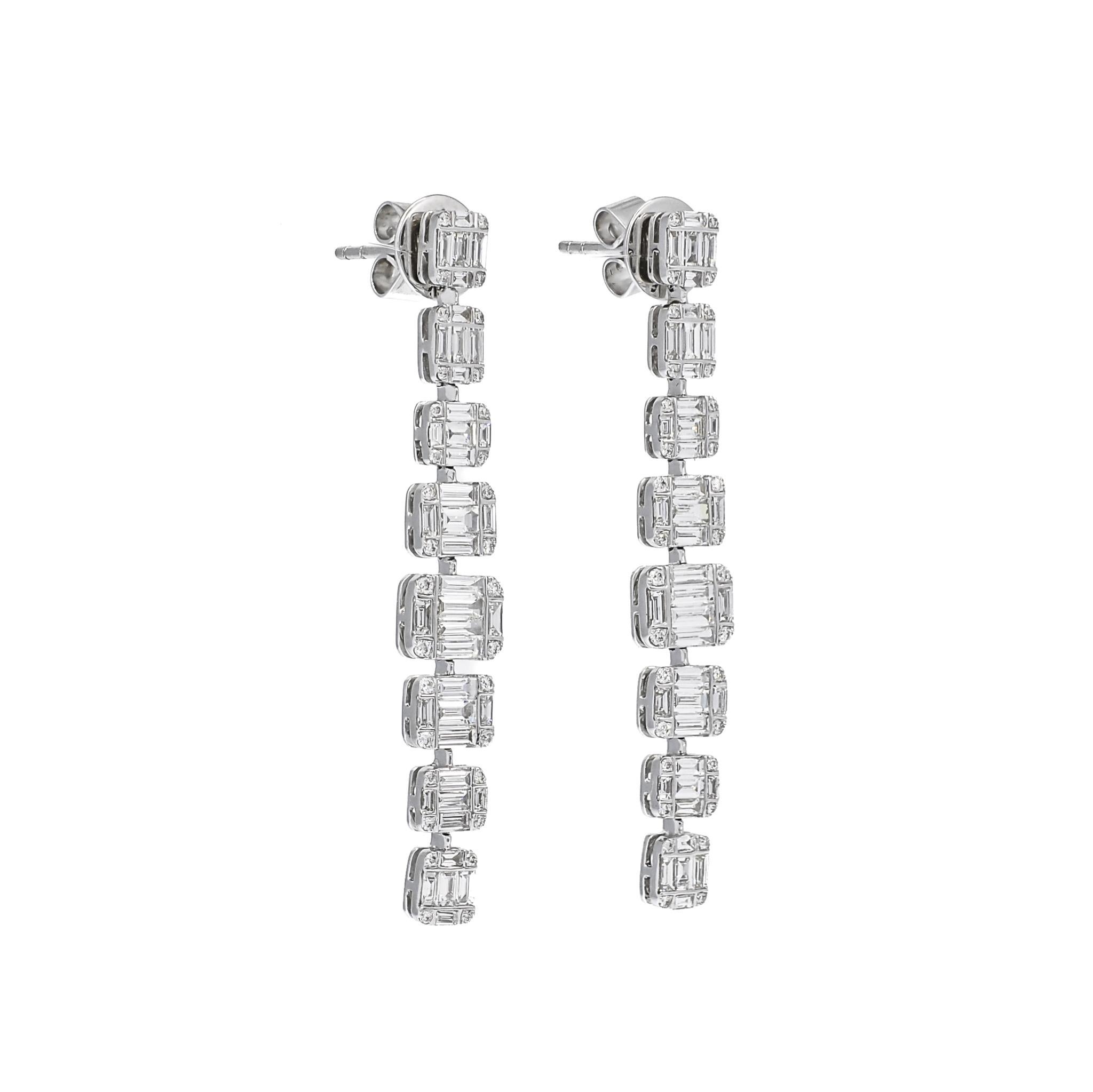 Indulge in the epitome of luxury with the exquisite 18KT White Gold Baguette Round 8 Graduating Cluster Drop Dangler Earrings. This remarkable piece transcends ordinary elegance, captivating the discerning eye with its opulent design and impeccable
