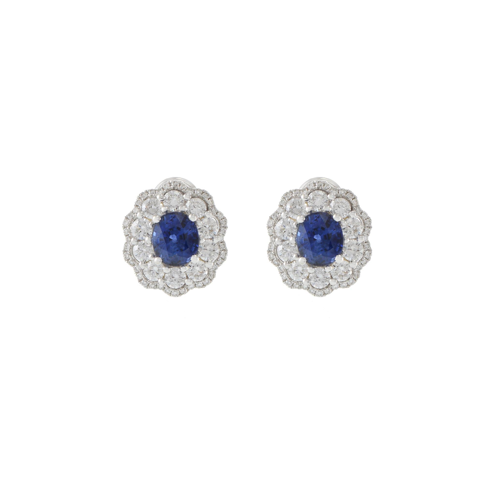These earrings feature an impressive 2.69CT-TW oval cut genuine blue sapphires set in 18KT white gold with 1.58CT-TW of F-grade, VS1-VS2 clarity round cut diamonds. This stunning pair is GAL certified for authenticity.