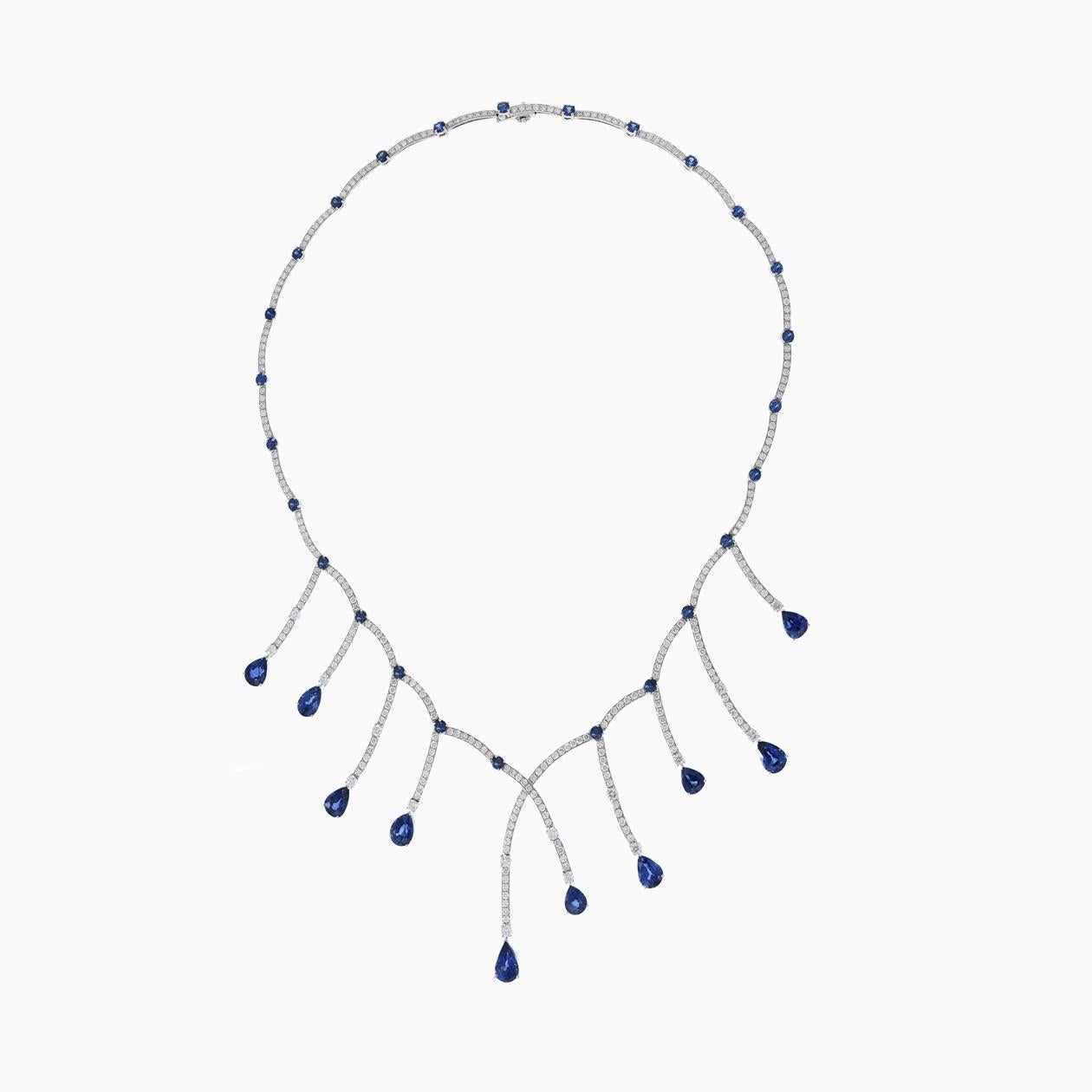 Elegant 18KT white gold bib necklace featuring 16.12 carats of pear and round cut, genuine blue sapphires accented with 5.91 carats of G-VS round cut diamonds. 22.3 gm. 16 inches.