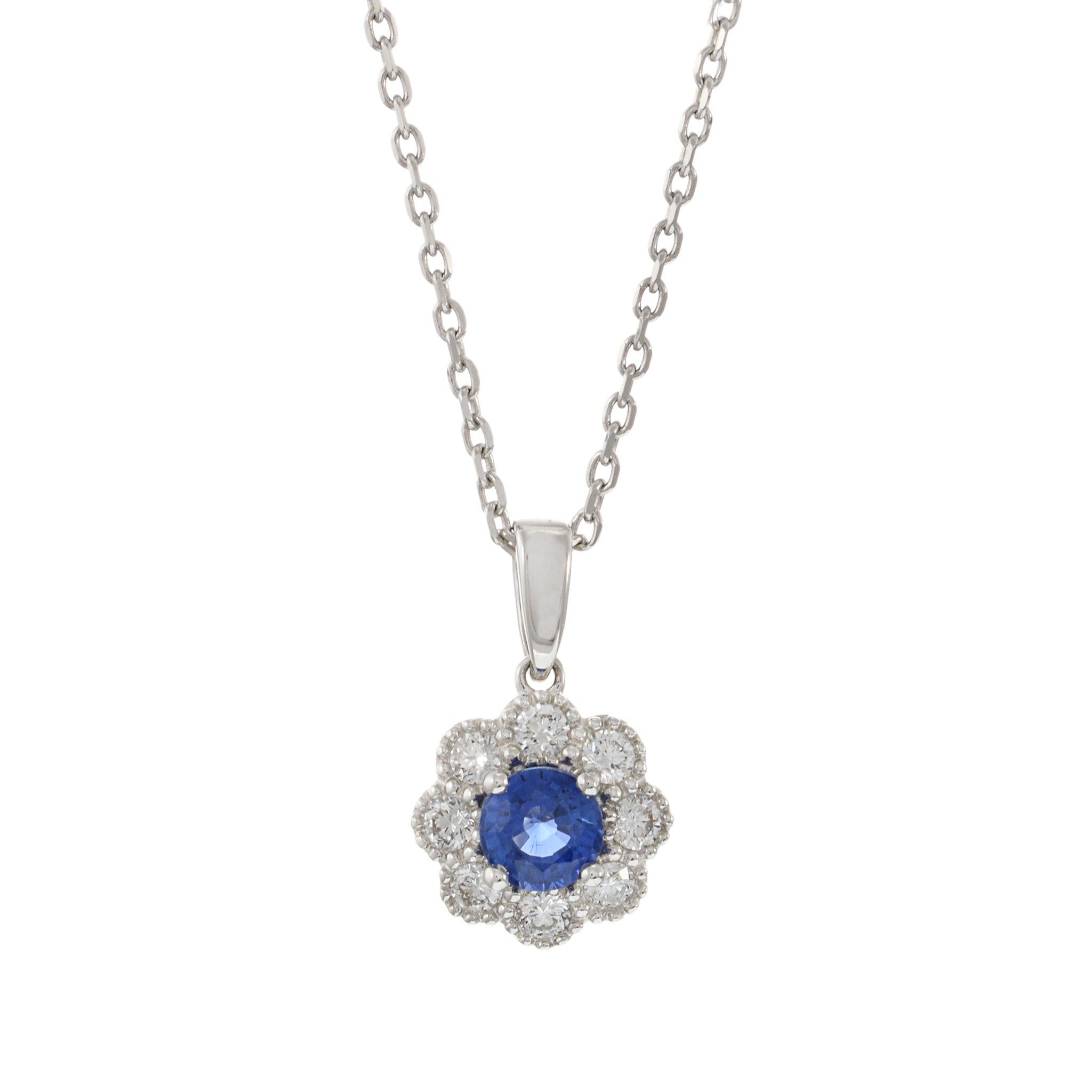 This elegant necklace features a 0.56 carat round cut blue sapphire, beautifully set in 18KT white gold. The vibrant sapphire is surrounded by 0.24 carats of round cut diamonds, creating a dazzling halo effect. This pendant is perfect for adding a