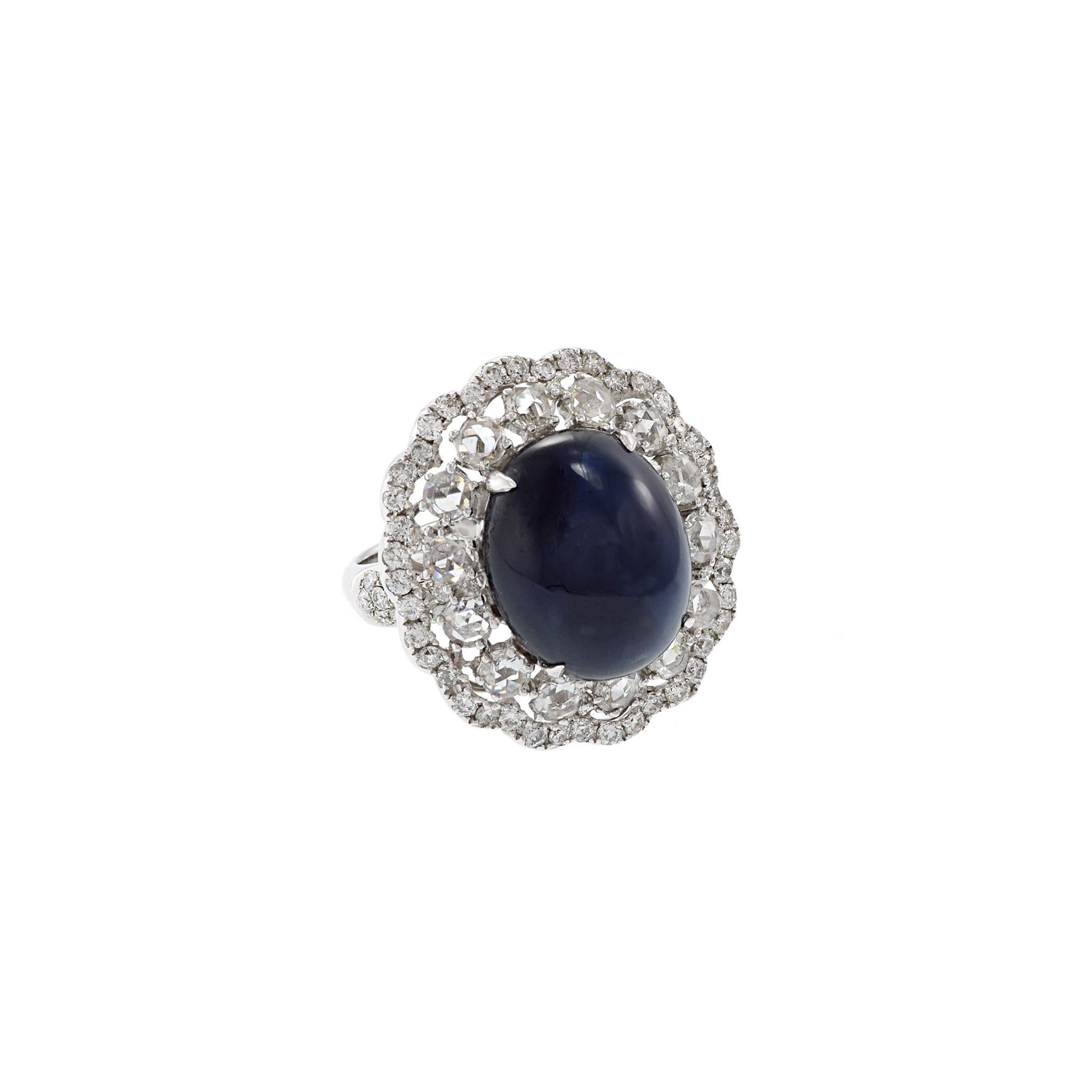 This exquisite piece of jewelry features meticulously designed 14.01CT oval cut cabochon cut blue sapphire surrounded by  2.52CT-TW of GAL certified rose and round cut diamonds, all crafted from 18KT white gold for an elegant statement. Size 6 US.