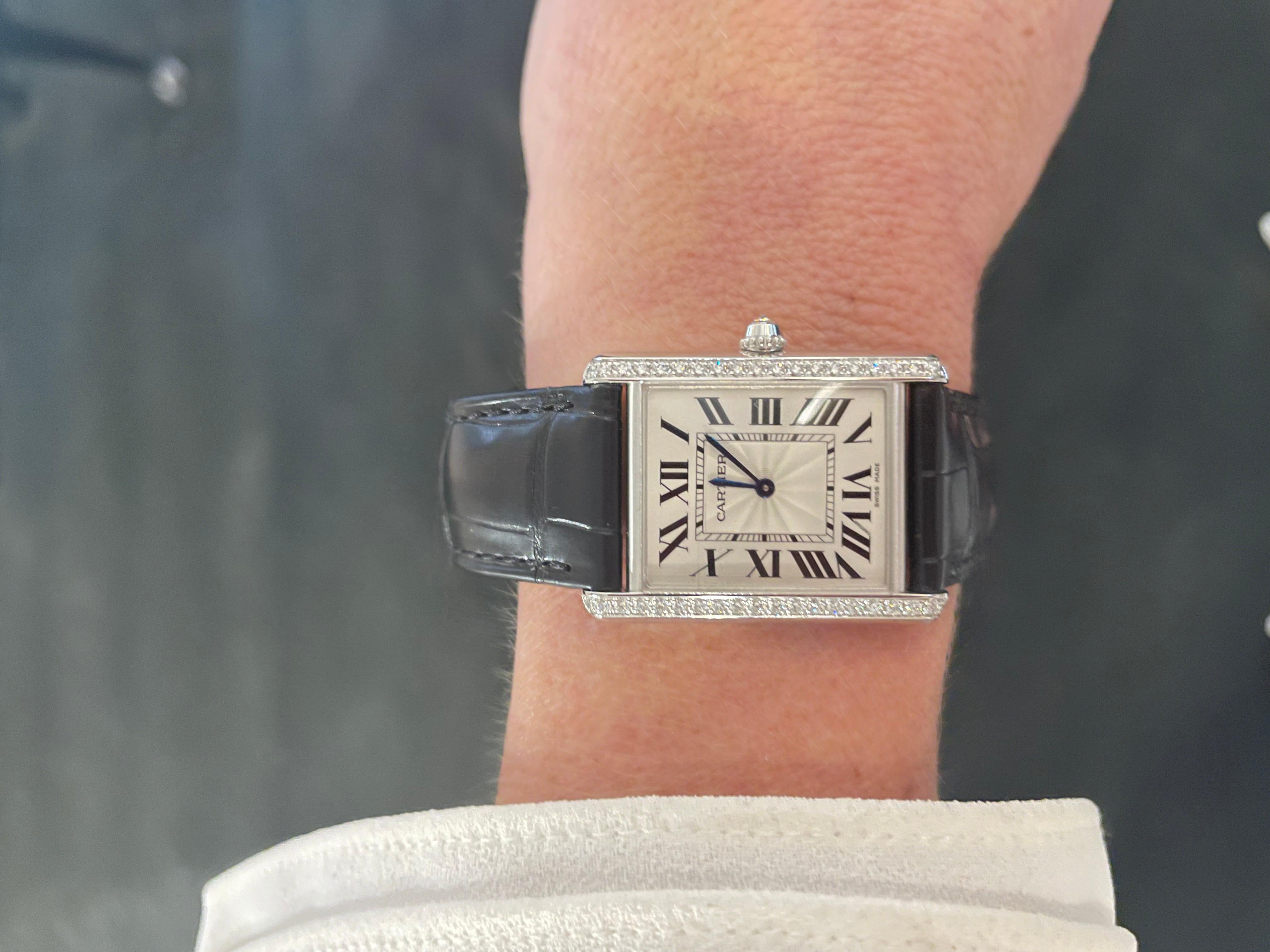 Classic Cartier known as the Tank Louis watch is stunning in 18kt white gold accented with 40 diamonds on the original black alligator watch band and comes with a pink alligator band as well.

This watch includes the original box and papers from