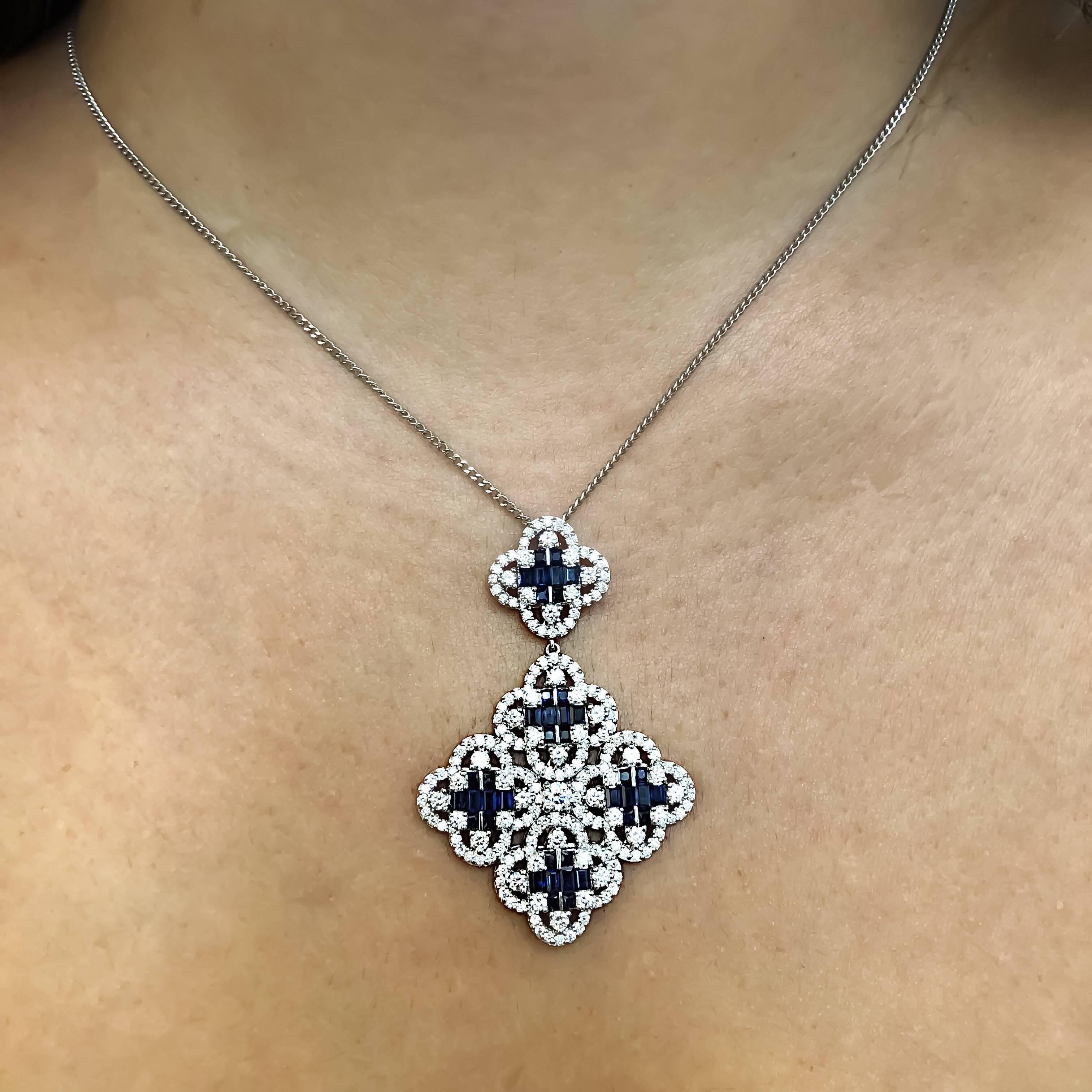 Gorgeous 18kt white gold Clover pendant.
Mounted with 2.68ct of white brilliant cut diamonds and 2.64ct of elongated baguette cut natural blue sapphire gemstones.
Comes with an 18kt white gold chain.

Matching earrings are available.