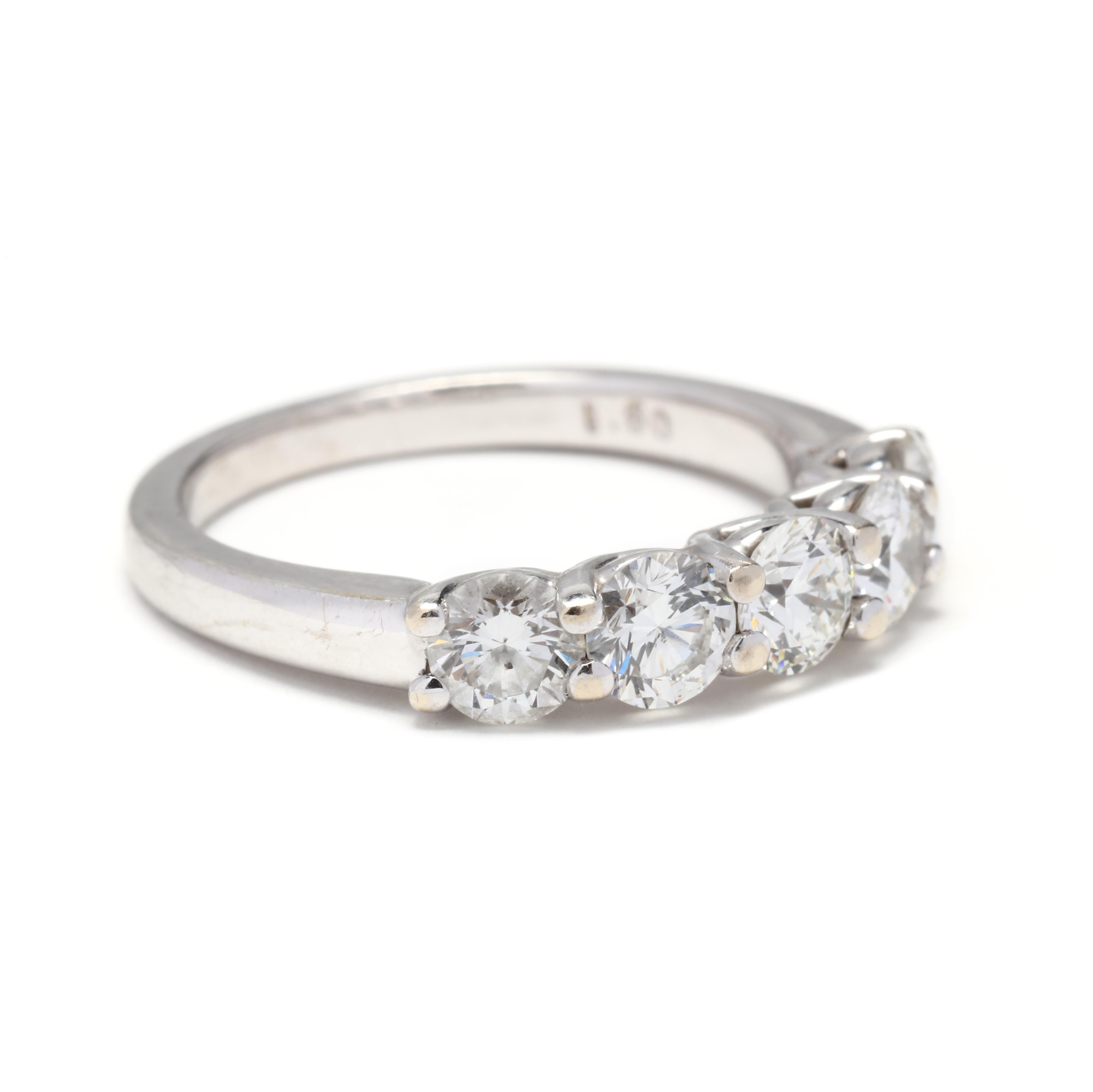 An 18 karat white gold five stone diamond band. This ring features five prong set round brilliant cut diamonds weighing approximately 1.60 total carats, set across the finger and with a slightly tapered shank.

Stones:

- diamonds, 5 stones

- round