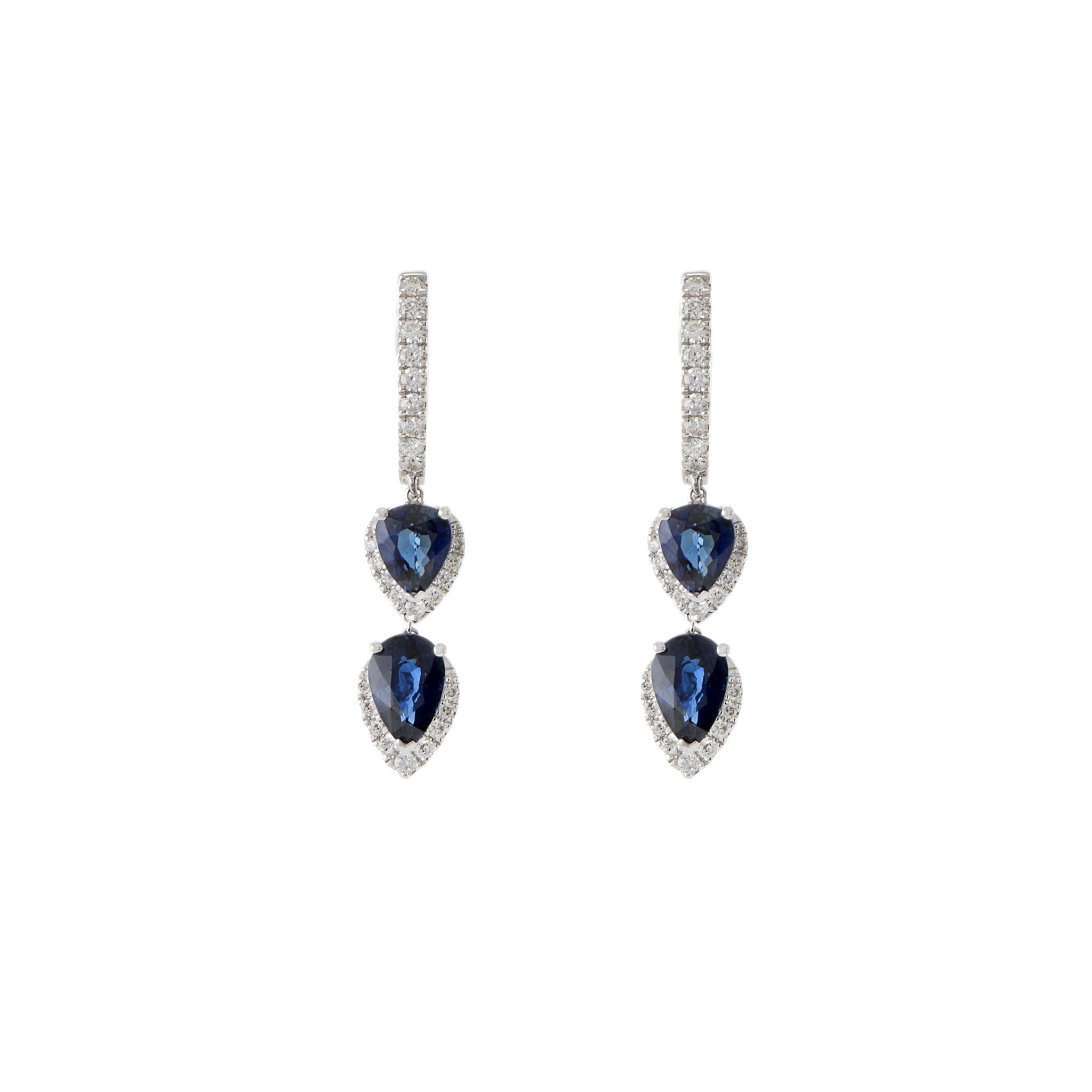 Make a statement with these 18KT white gold double drop earrings where genuine pear-cut blue sapphires take center stage, totaling 2.14CT-TW. Surrounded by a halo of 0.29CT-TW G color VS1-VS2 clarity round-cut diamonds, these earrings exude