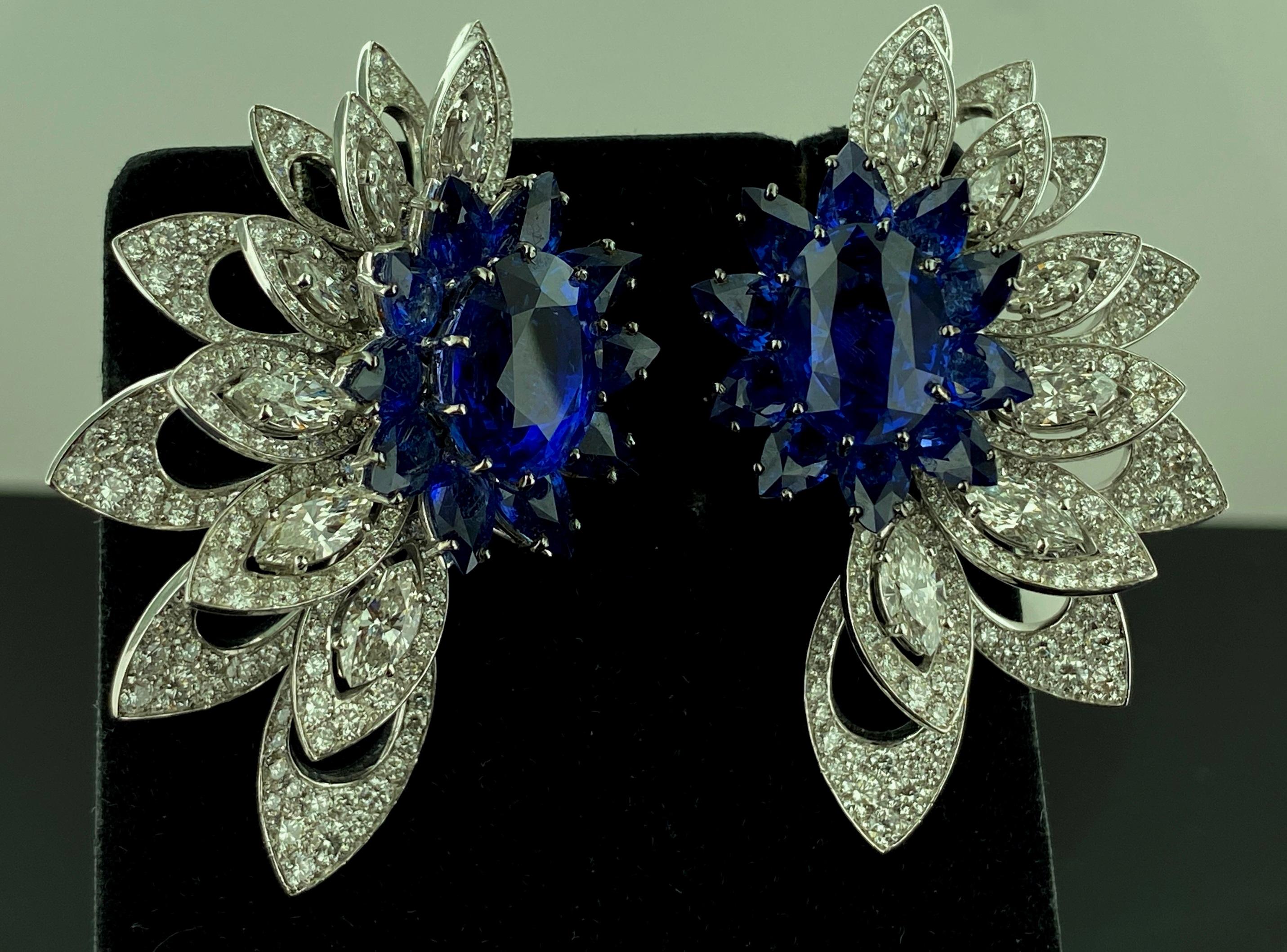 Set in 18 karat white gold are 7.00 carats of round and Marquise cut diamonds total diamond weight plus 20 pear shaped blue sapphires and 2 oval cut blue sapphires, 1-each in the center.  Total Sapphire weight is 22.47 carats.