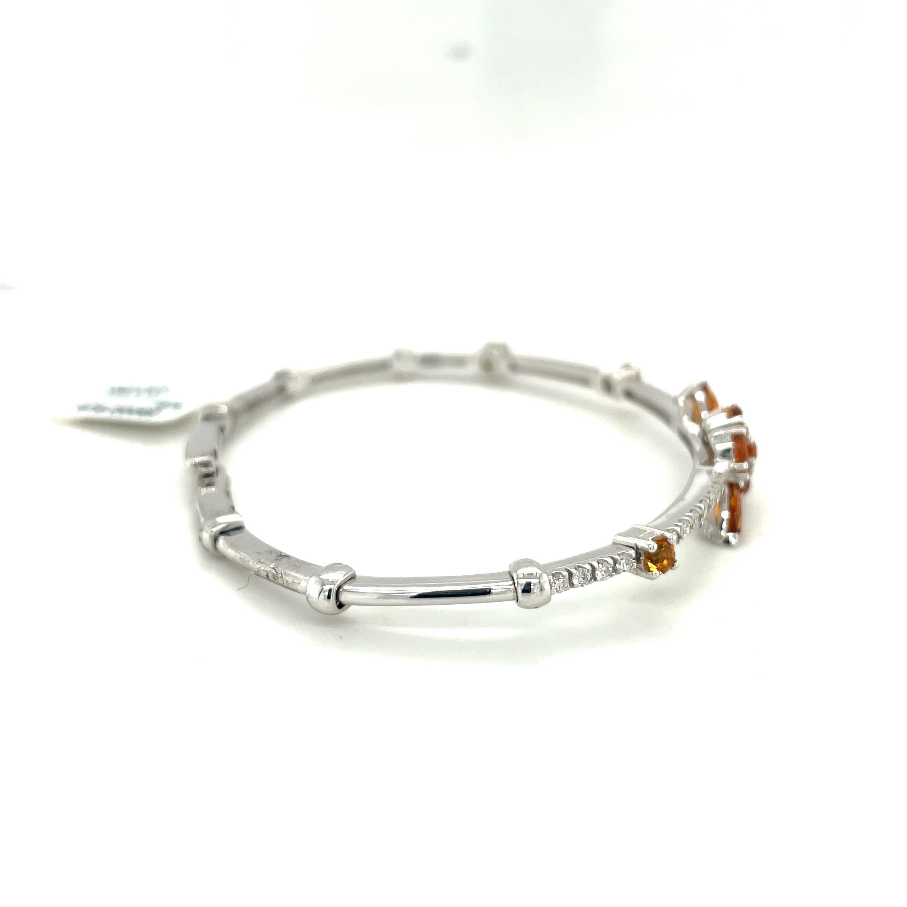 This beautiful flexible open back 18kt white gold bangle features 4 marquis cut citrines, totaling 0.30 cts, accented with 0.26 cts of white diamonds. The flexibility of the bangles makes these suitable for a wide range of wrist sizes and the slight