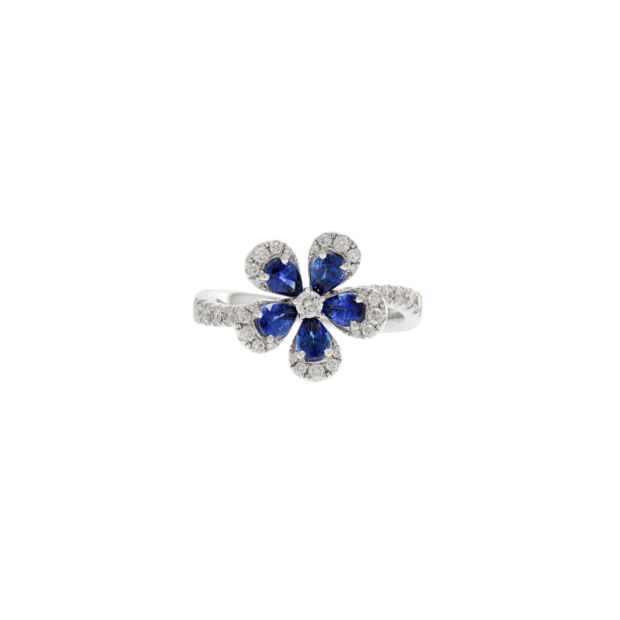 This exquisite 18KT white gold diamond and sapphire flower ring is crafted with 1.02CT-TW pear cut sapphires and 0.35CT-TW round cut diamonds for a timeless and elegant look. Size 6.25 US. Weight 4.3 gm.