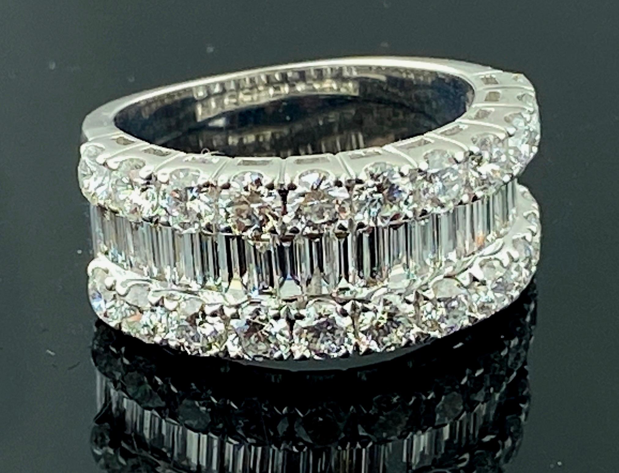 Set in 18 karat white gold, weighing 8 grams, are 22 round brilliant cut diamonds with a total weight of 2.00 carats plus 22 baguette cut diamonds weighing 1.00 carats for a total diamond weight of 3.00 carats.  Color: F-G, Clarity VS.  Ring size is