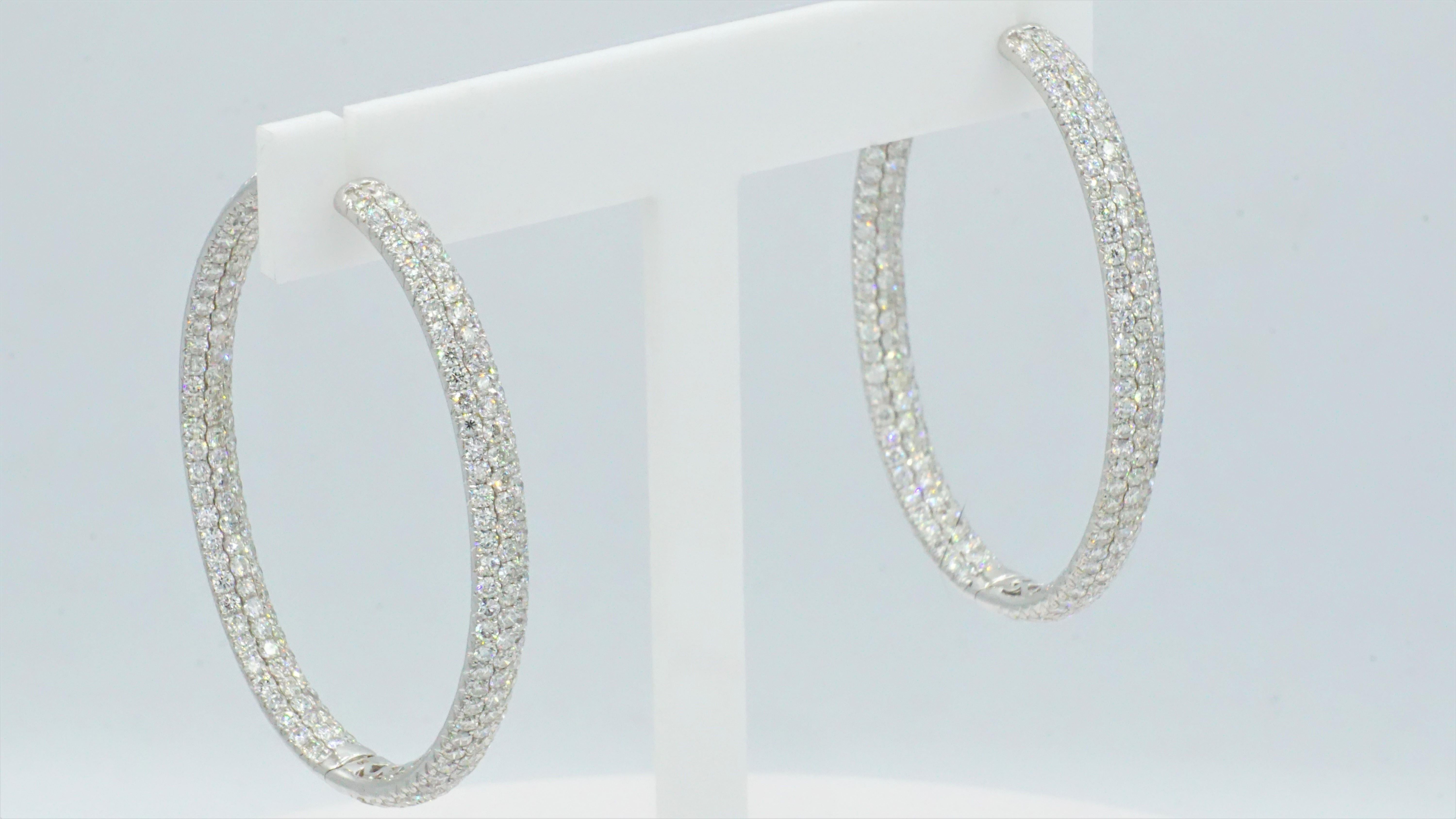 Beautifully-crafted 18kt white gold, hinged oval-shaped, inside-out pave diamond hoop earrings. These are stunning earrings in very condition and appears to be hardly worn.  Each earring measures 1 inch by 1.75 inches. Both earrings combined have a