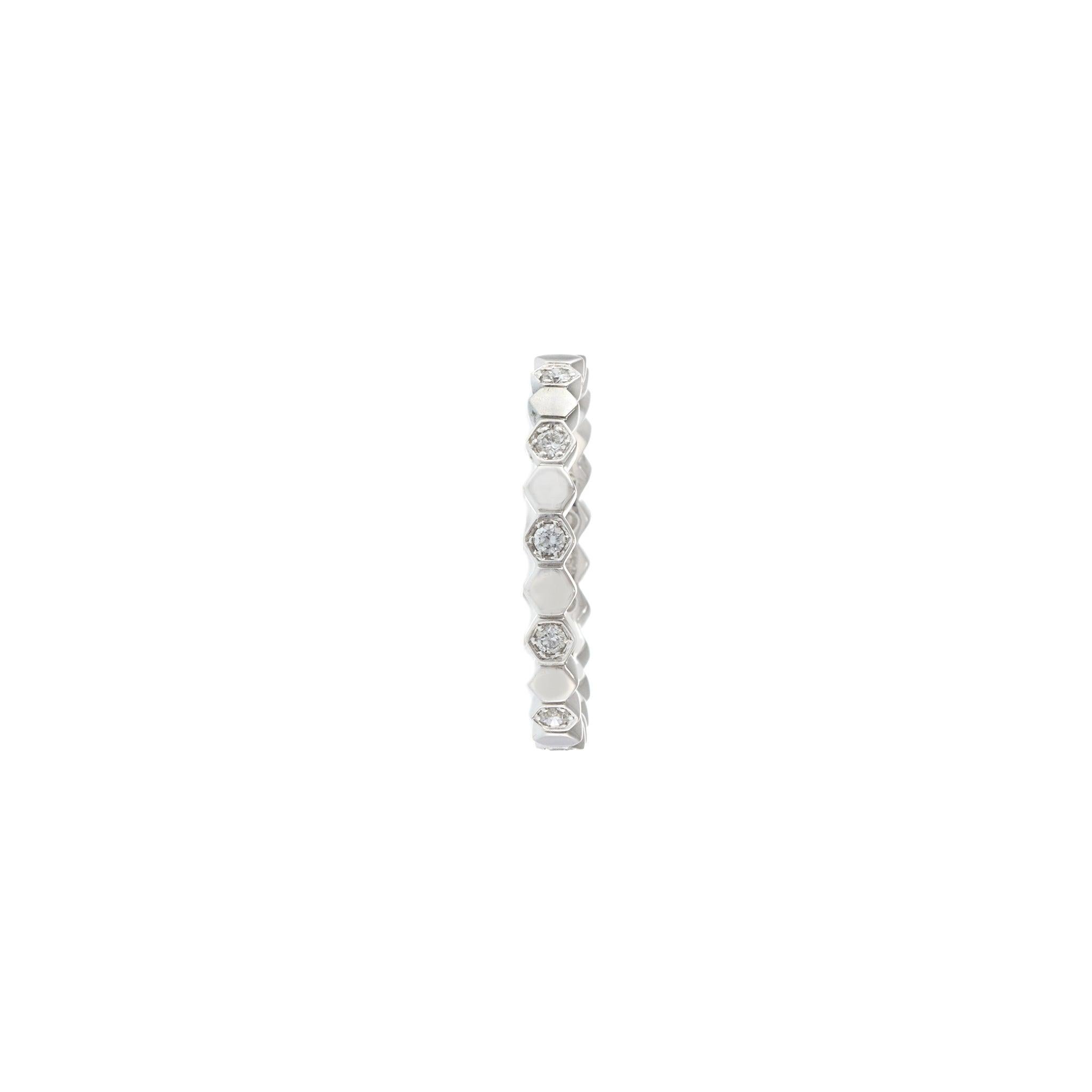 A modern twist on the eternity band, this 18KT white gold ring features a striking octagonal pattern, each segment bezel-set with a round brilliant diamond. With approximately 0.21 carats of G-VS quality stones, it blends geometric structure with