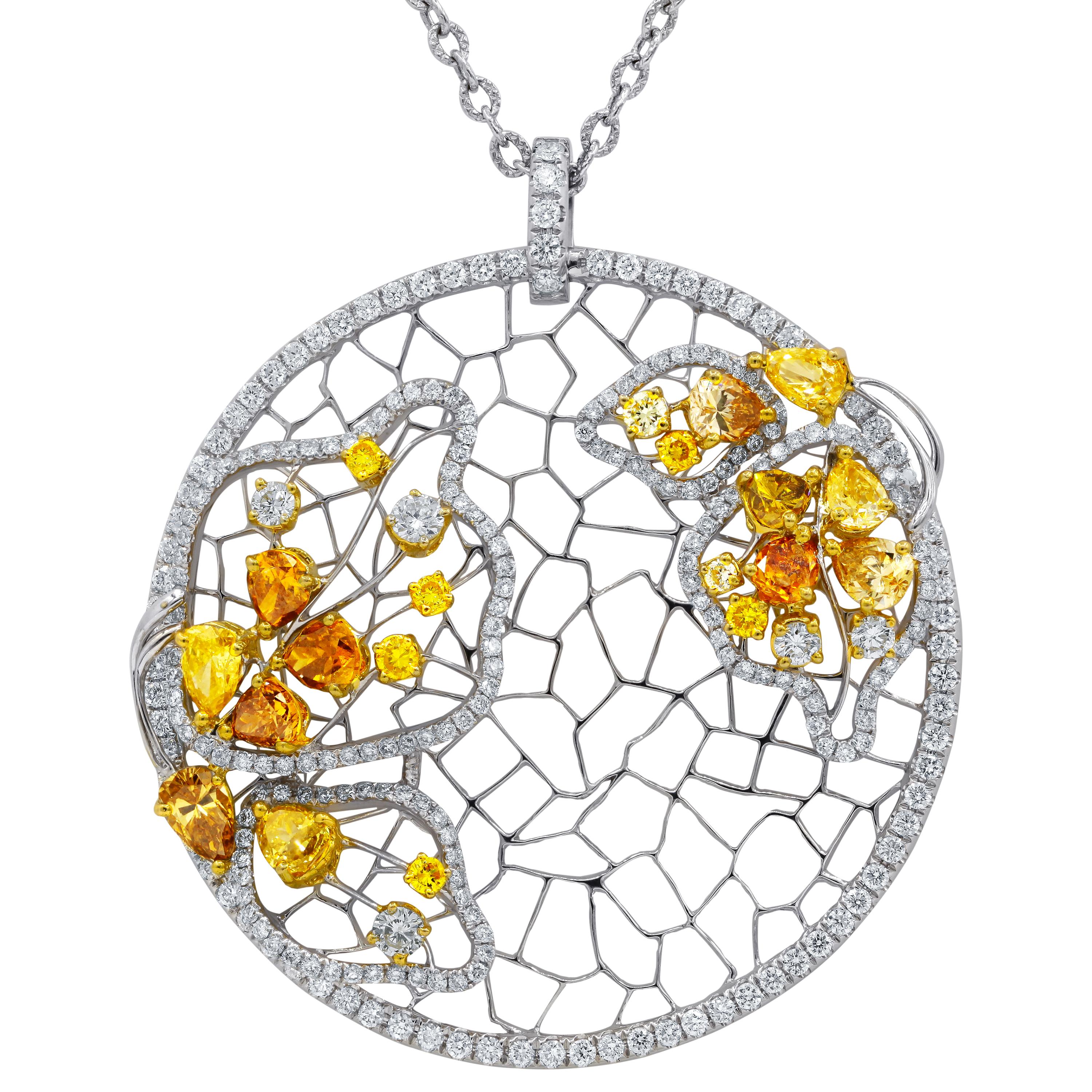 18kt white gold diamond pendant necklace features 5.59 carats of diamonds including fancy yellow and white.
