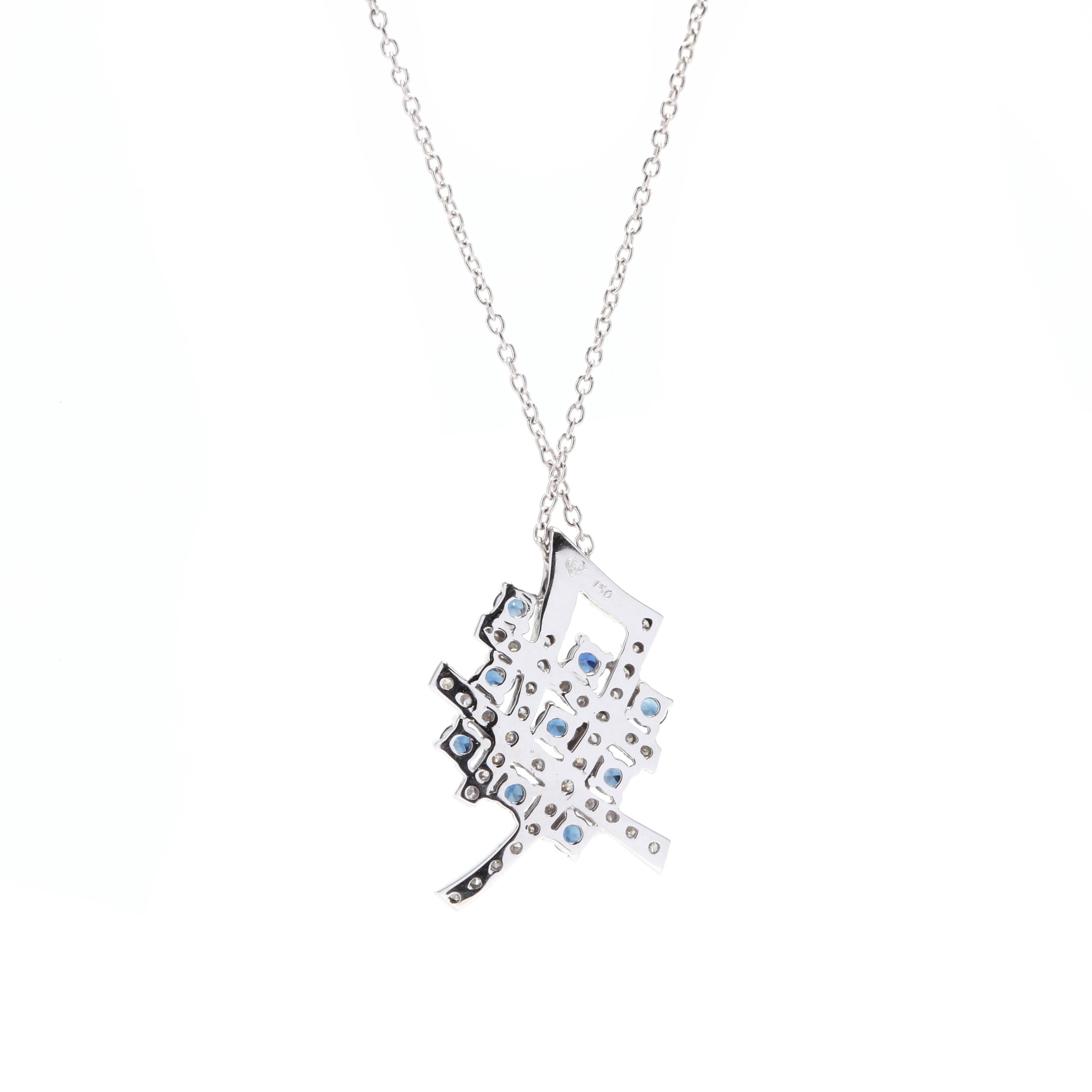 An 18 karat white gold, diamond and sapphire pendant necklace. Of a criss-cross design, set with round cut sapphires weighing approximately .40 total carats and round full cut diamonds weighing approximately .50 total carats and with a thin cable