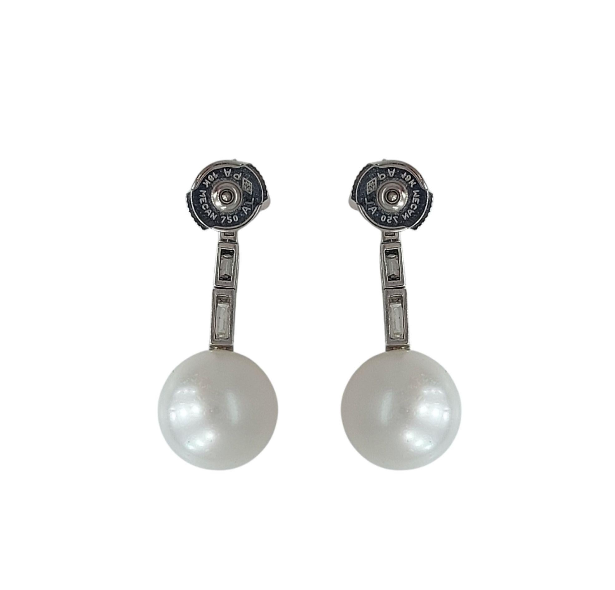 Magnificent 18kt White Gold Earrings With Pearl and Baguette Earrings 

Pearl: South Sea Diameter pearl 12mm

Diamonds: 8 baguette cut diamonds

Material: 18 kt white gold

Measurements: 33 x 2.5 mm

Total weight: 8.7 grams / 5.6 dwt / 0.310 oz
