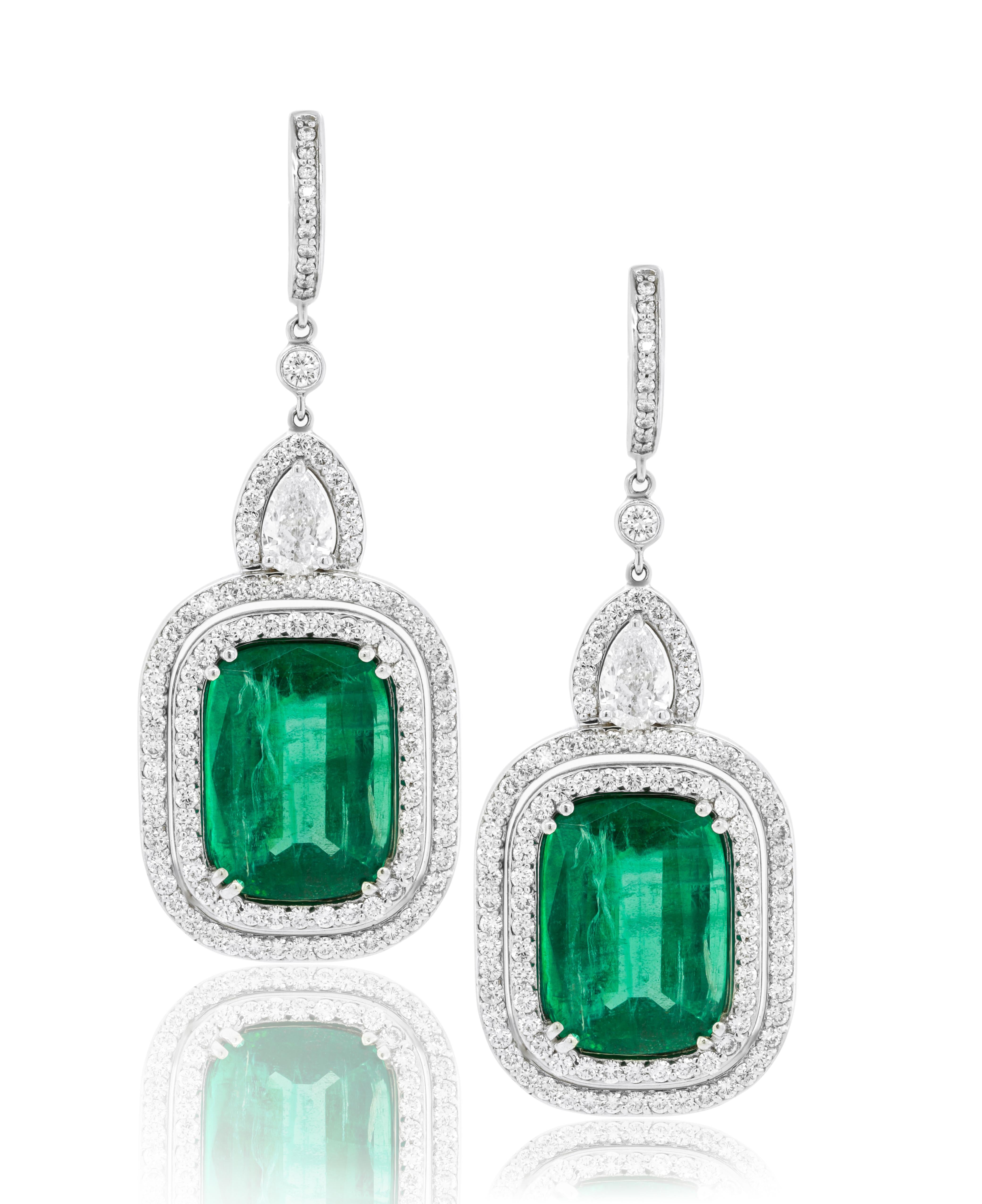 18kt white gold, emerald and diamond earrings features 27.10 carats of GIA
Certified emeralds. surrounded by 3.50 carats of diamonds in a double halo design