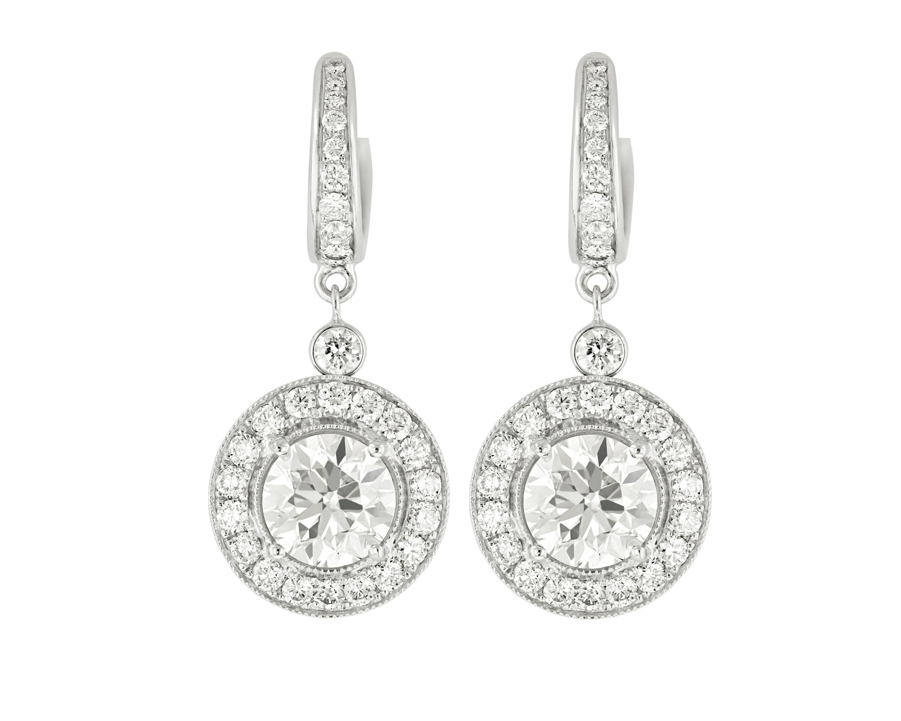 18kt white gold diamond earrings with center  4.75 round diamonds set  in diamond  bezel on the diamond huggies earring, features 1.90ct