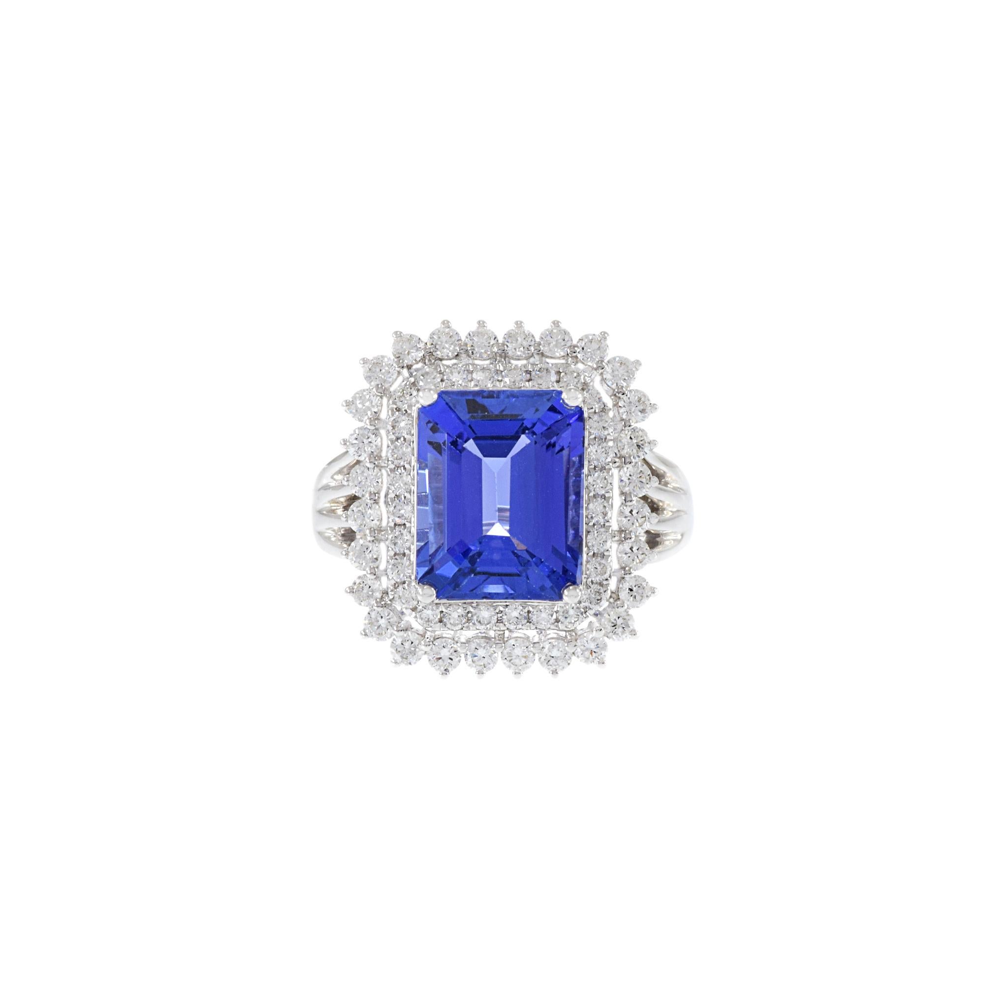 This beautiful 18KT white gold, consisting of a 4.41CT-TW emerald cut tanzanite surrounded by 0.87CT-TW G-VS/SI round-cut diamonds with a double halo ring will make any special occasion shine. With its classic elegance, it will be an unforgettable