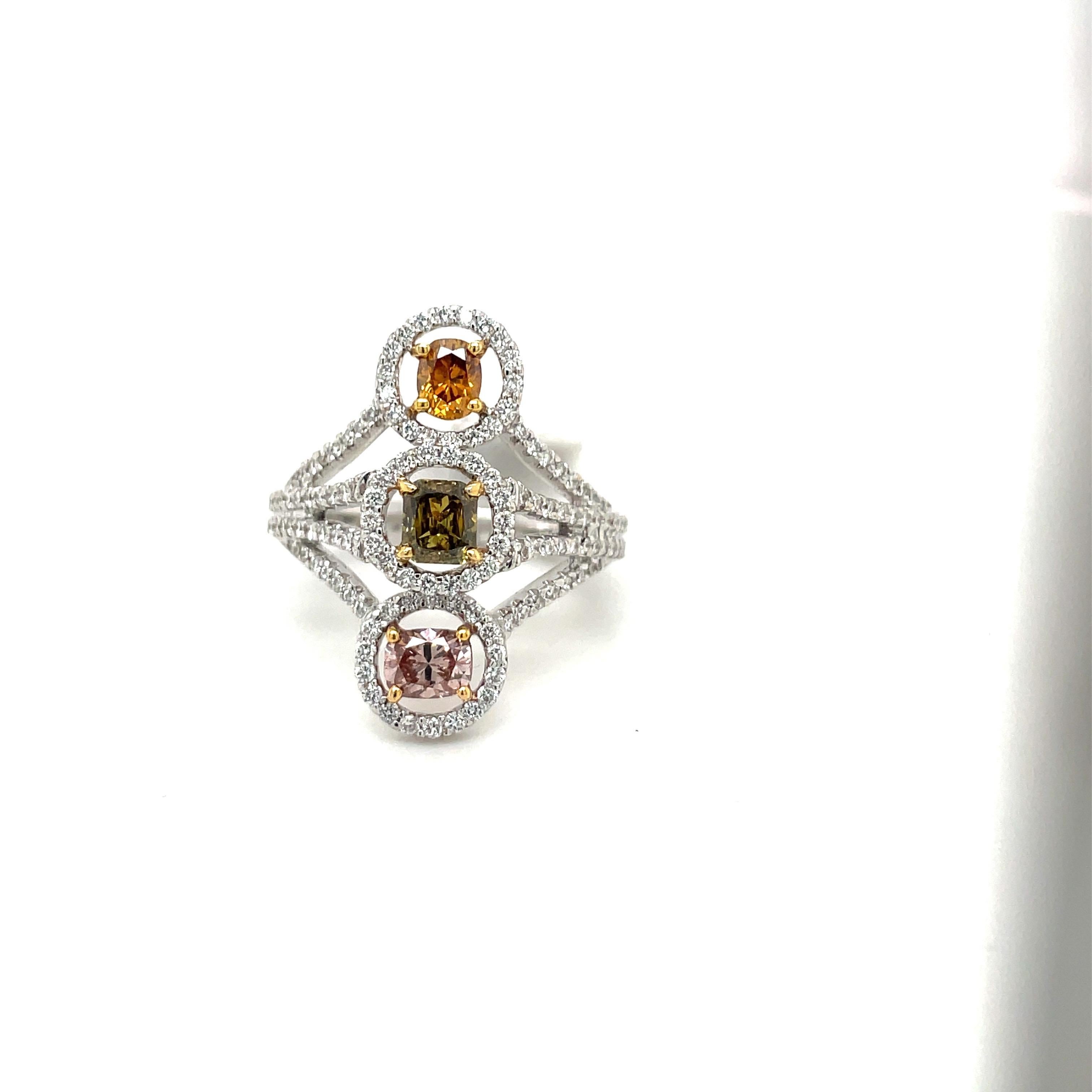 This 18 karat white gold ring is set with 3 fancy colored radiant diamonds. The radiant cut orange , green and pink diamonds have a total weight of 1.02 carats. The setting is white diamonds with a total weight of 0.70 carats.
Ring size 6
Stamped La