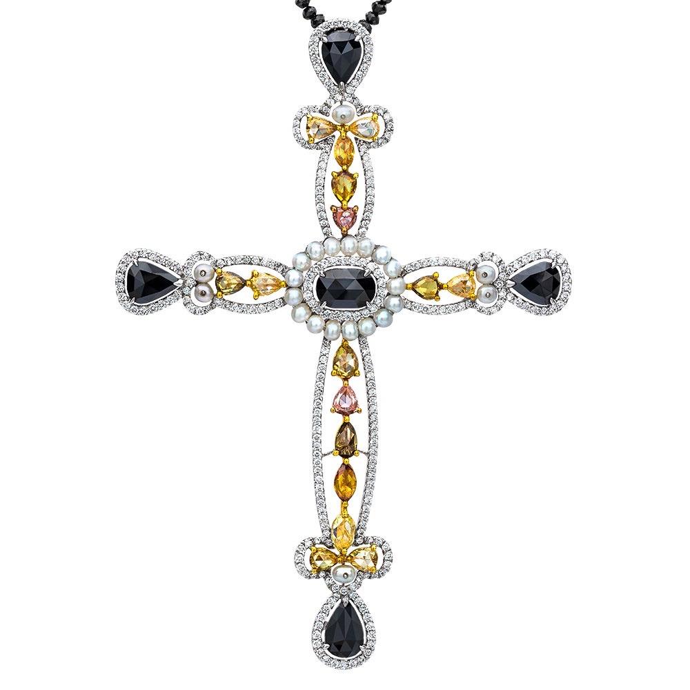 This incredible 18 karat white gold cross is set with a beautiful palette of Mixed Fancy Colored Diamonds. The Fancy Colored Diamonds in the yellow to brown colors are set in yellow gold. Round Brilliant and Rose Cut stones of pear, marquis, round