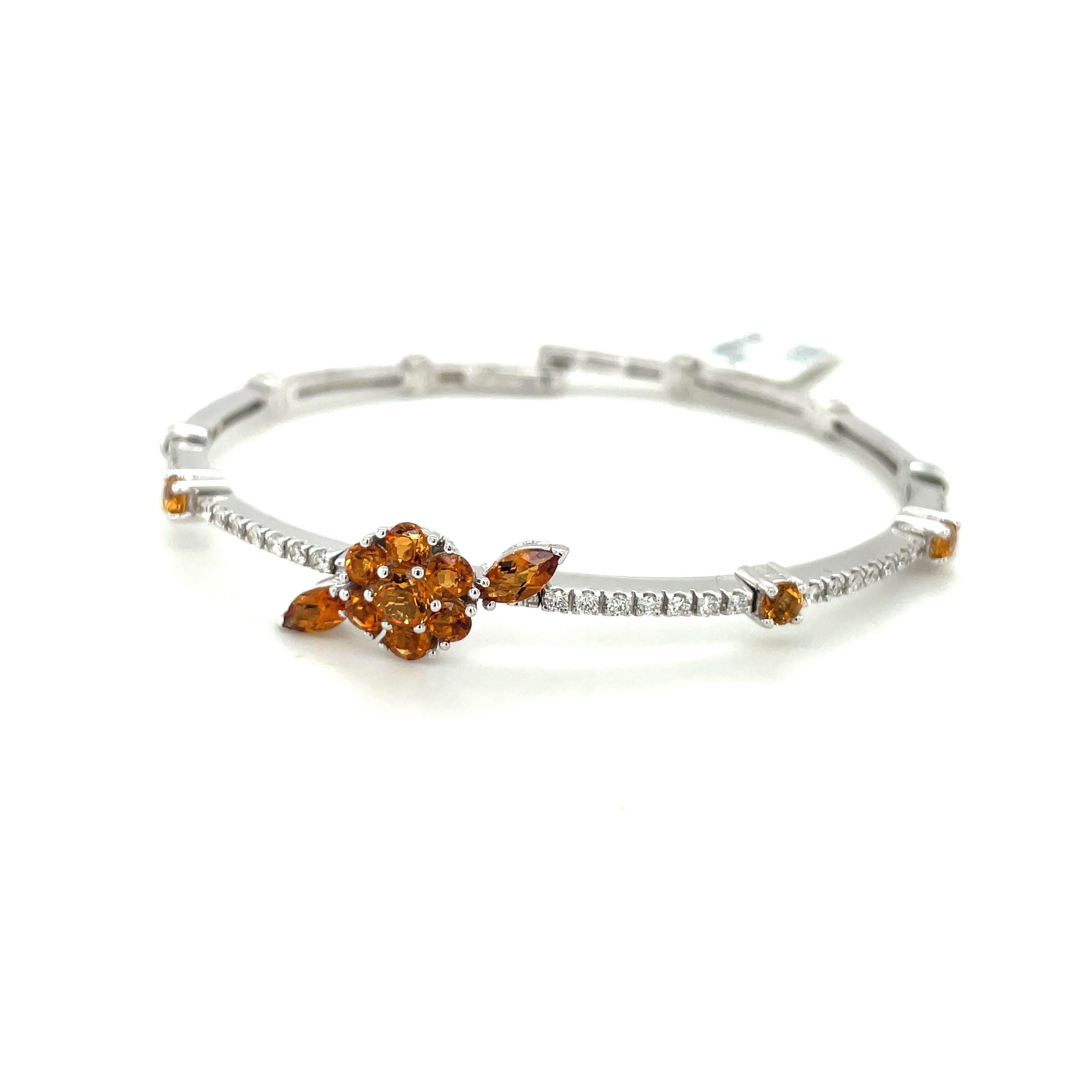 This beautiful flexible open back 18kt white gold bangle features a beautiful citrine flower, totaling 0.30 cts, accented with 0.40 cts of white diamonds. The flexibility of the bangles makes these suitable for a wide range of wrist sizes and the