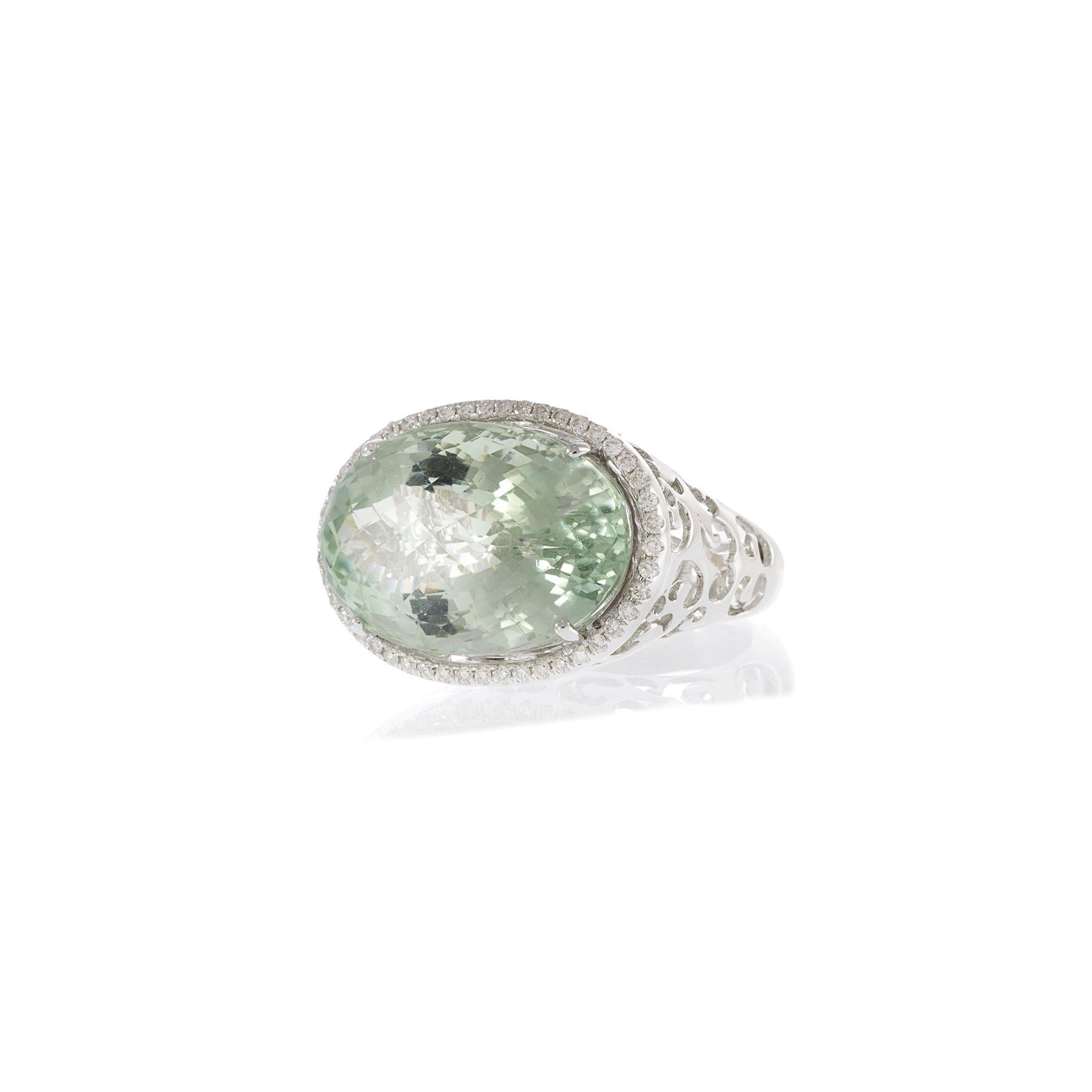 A bold expression of elegance, this statement ring pairs modern artistry with classic luxury. Crafted in 18KT white gold, the design features an impressive 20.36 carat green amethyst, sparkling with a soft mint hue and checkerboard facets. A