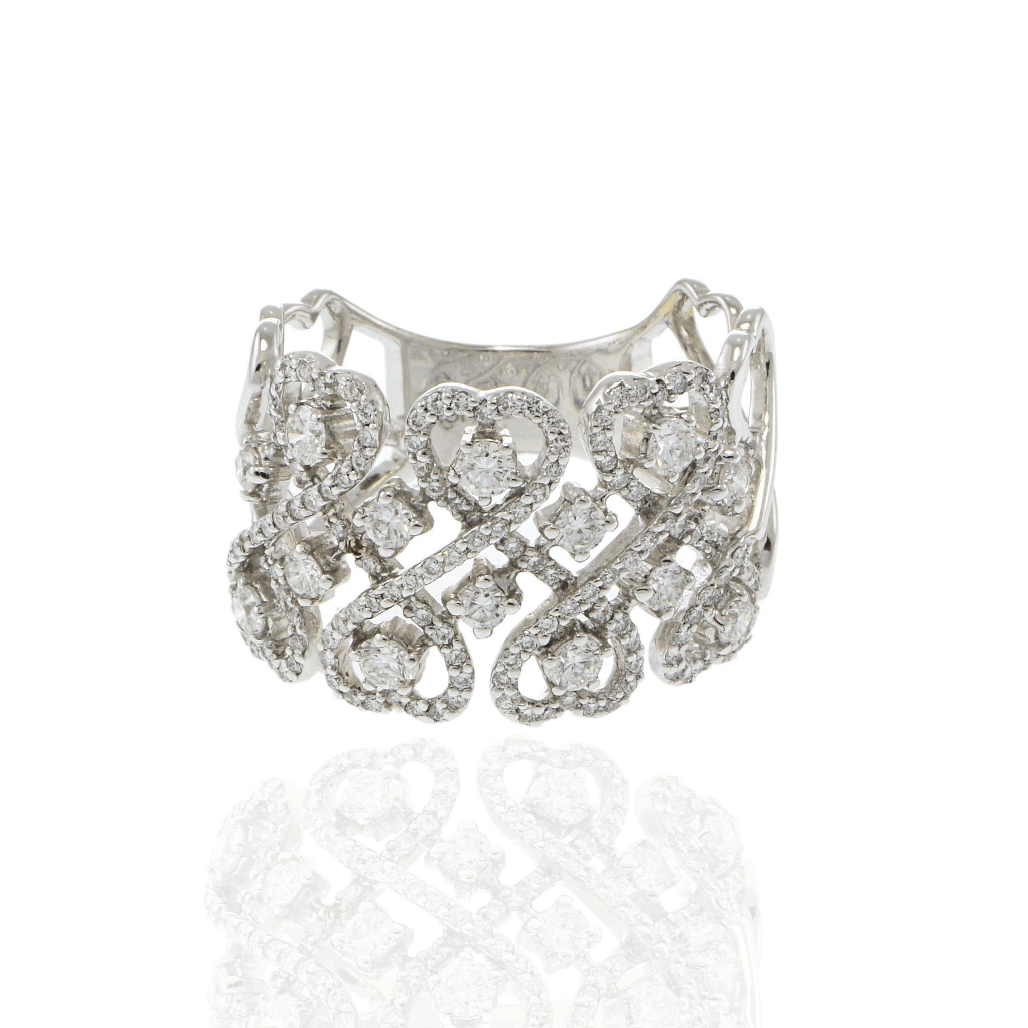 A symphony of elegance and sparkle.

This exquisite ring showcases a dazzling 1.0 carat round diamond, radiating with a pristine white hue. The intricate design features a series of interwoven loops making hearts, each encrusted with smaller