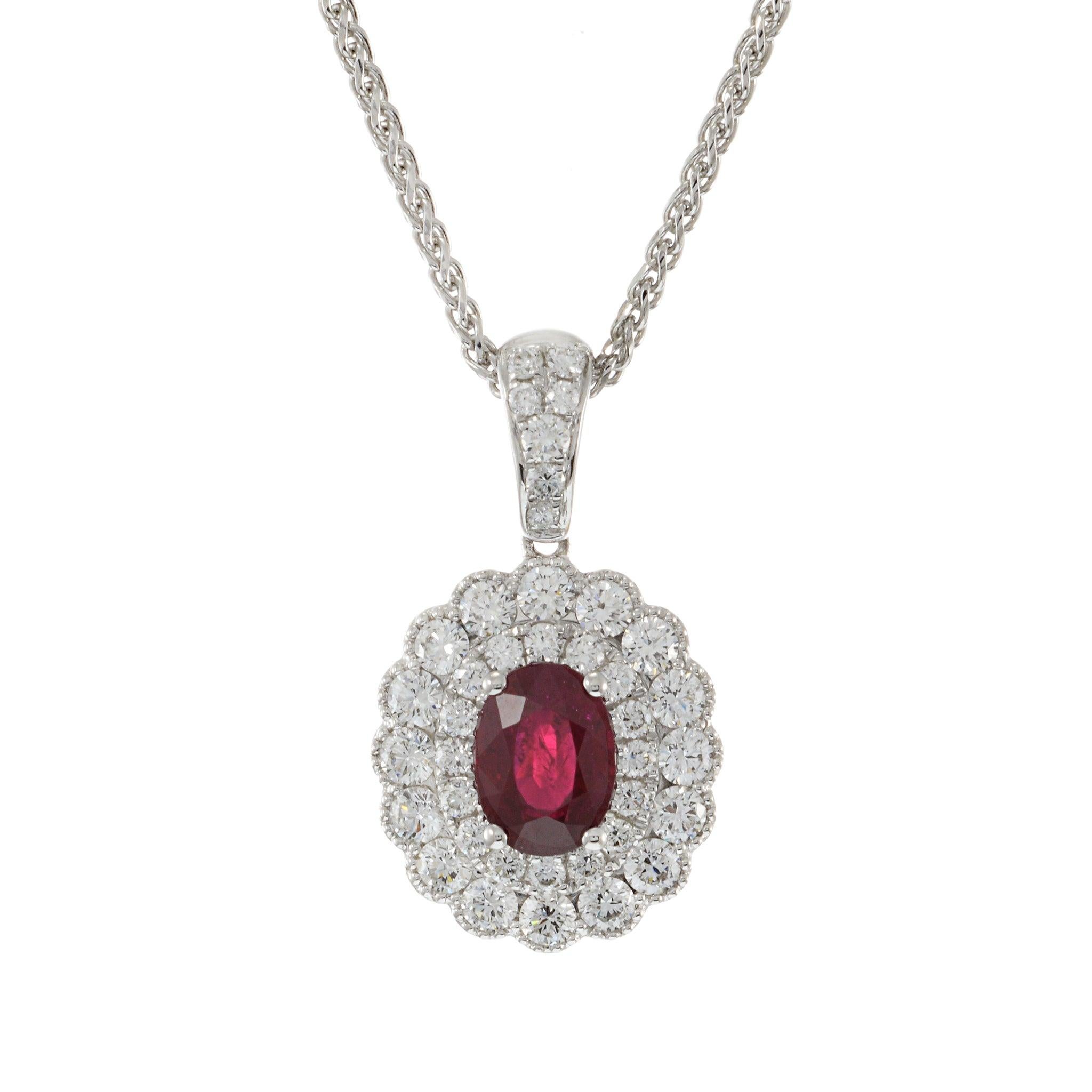 This stunning pendant features a 1.25 carat oval cut genuine ruby, beautifully set in 18KT white gold. The vibrant ruby is surrounded by 0.88 carats of round cut diamonds, with G-H color and VS clarity, adding a sparkling halo that enhances the