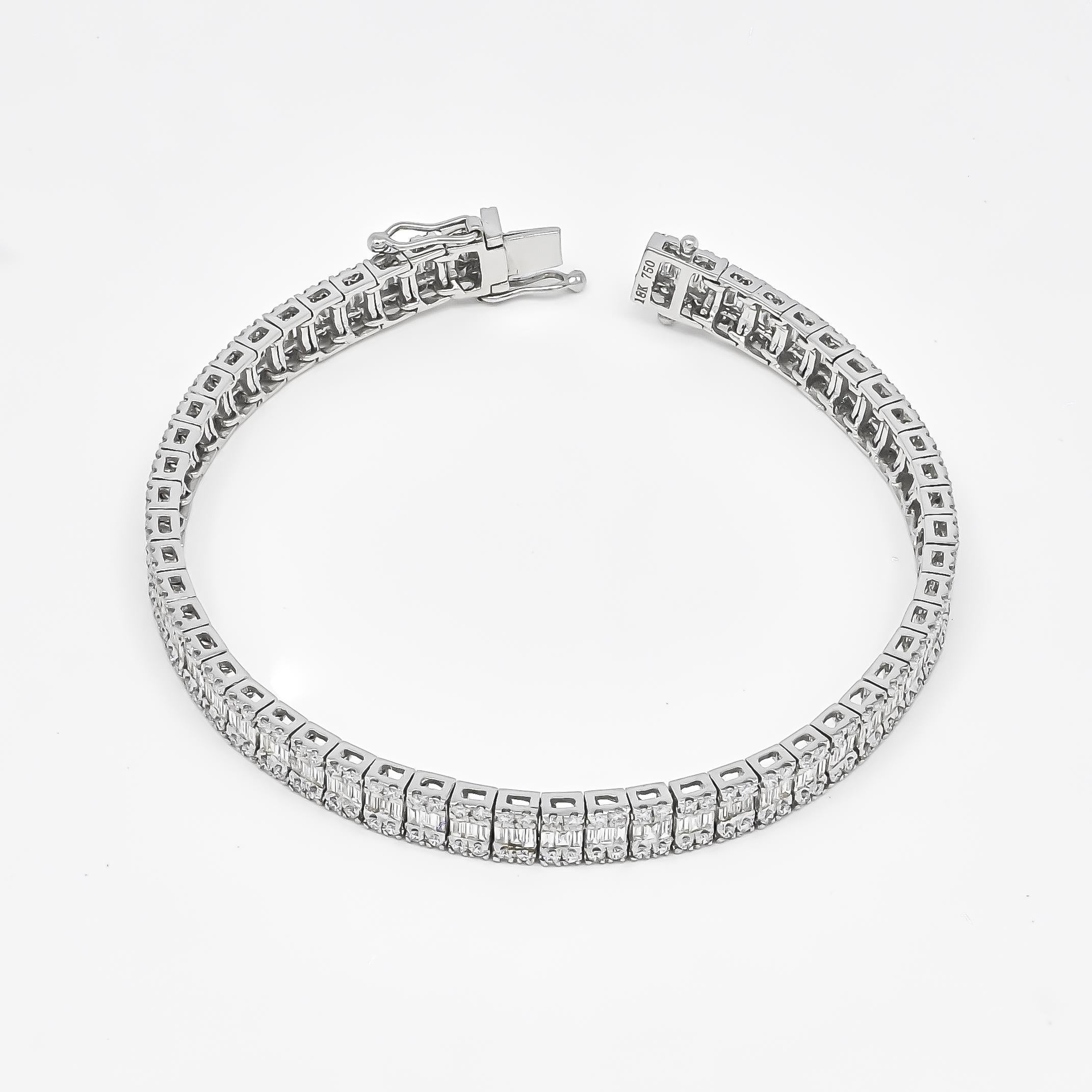 Artfully set in 18KT white gold, this exquisite bracelet features the soft shimmer of diamond baguette diamonds gorgeously enhanced by round-shape diamond borders.

The bracelet showcases a delicate dance of diamond baguettes, each one contributing