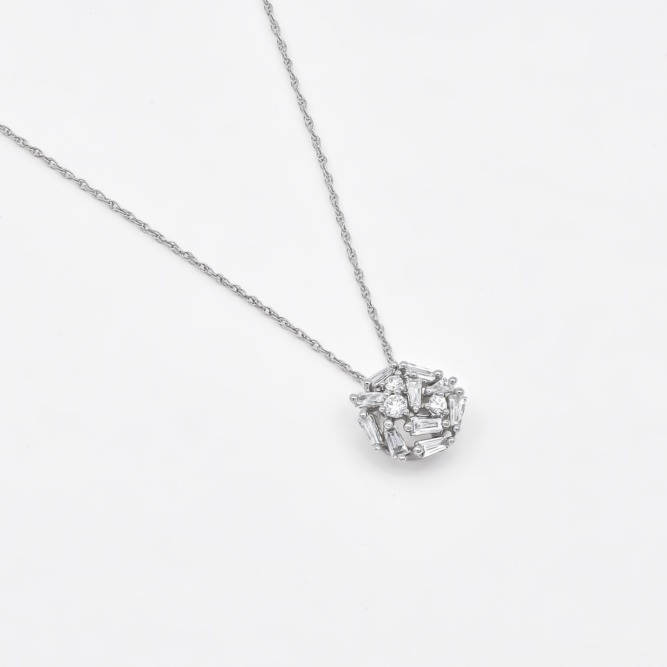 Indulge in the breathtaking beauty of this pendant necklace, adorned with a scattered cluster of round and baguette diamonds set in luxurious 18KT White Gold. Totaling 0.44 carats, the arrangement of diamonds in this pendant creates a dramatic and