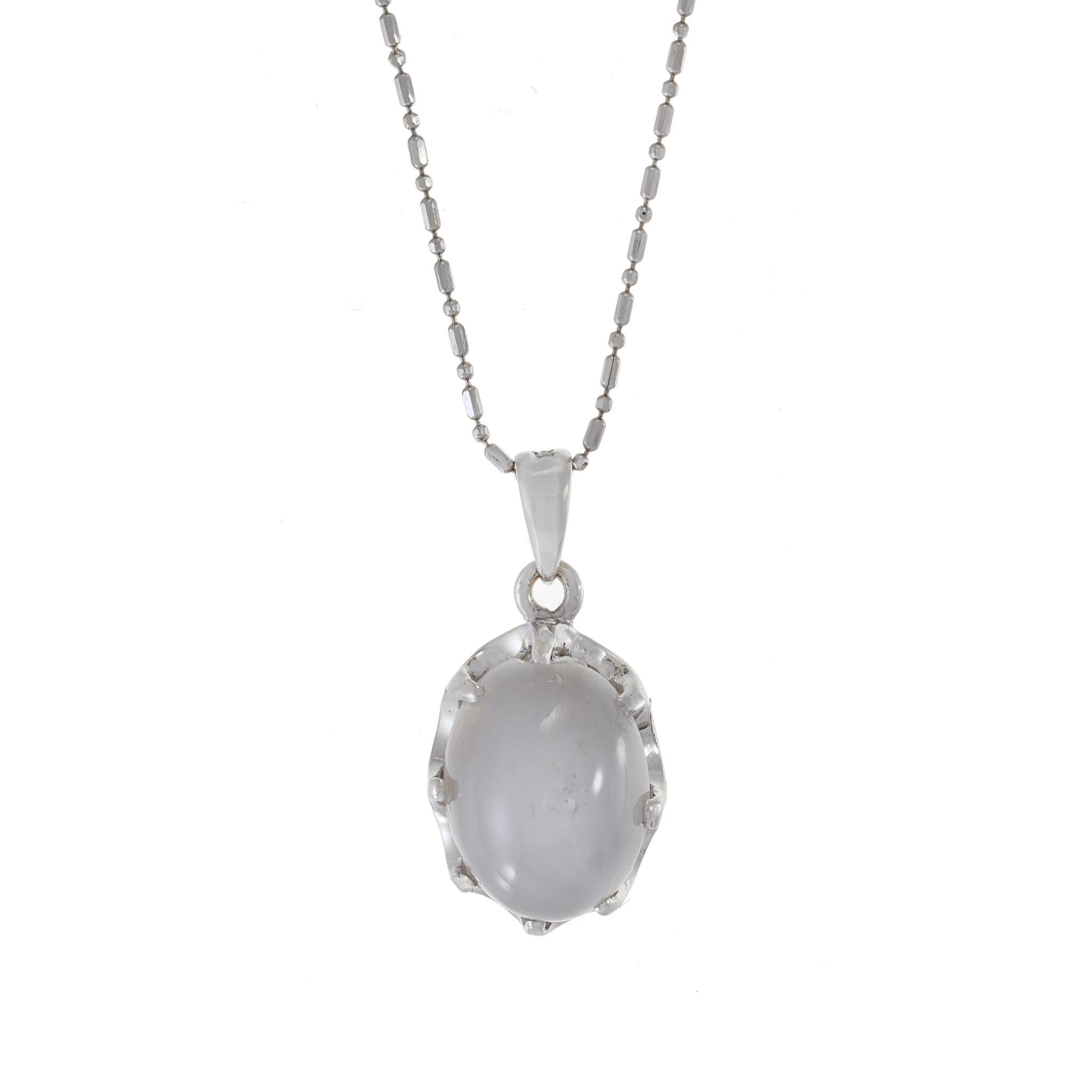 Indulge in the allure of extravagance with this exquisite 14KT white gold pendant featuring a remarkable 10.01CT natural oval grey star cabochon sapphire. Suspended from a 16-inch mini ball and bar 14KT chain, this pendant is a statement piece that
