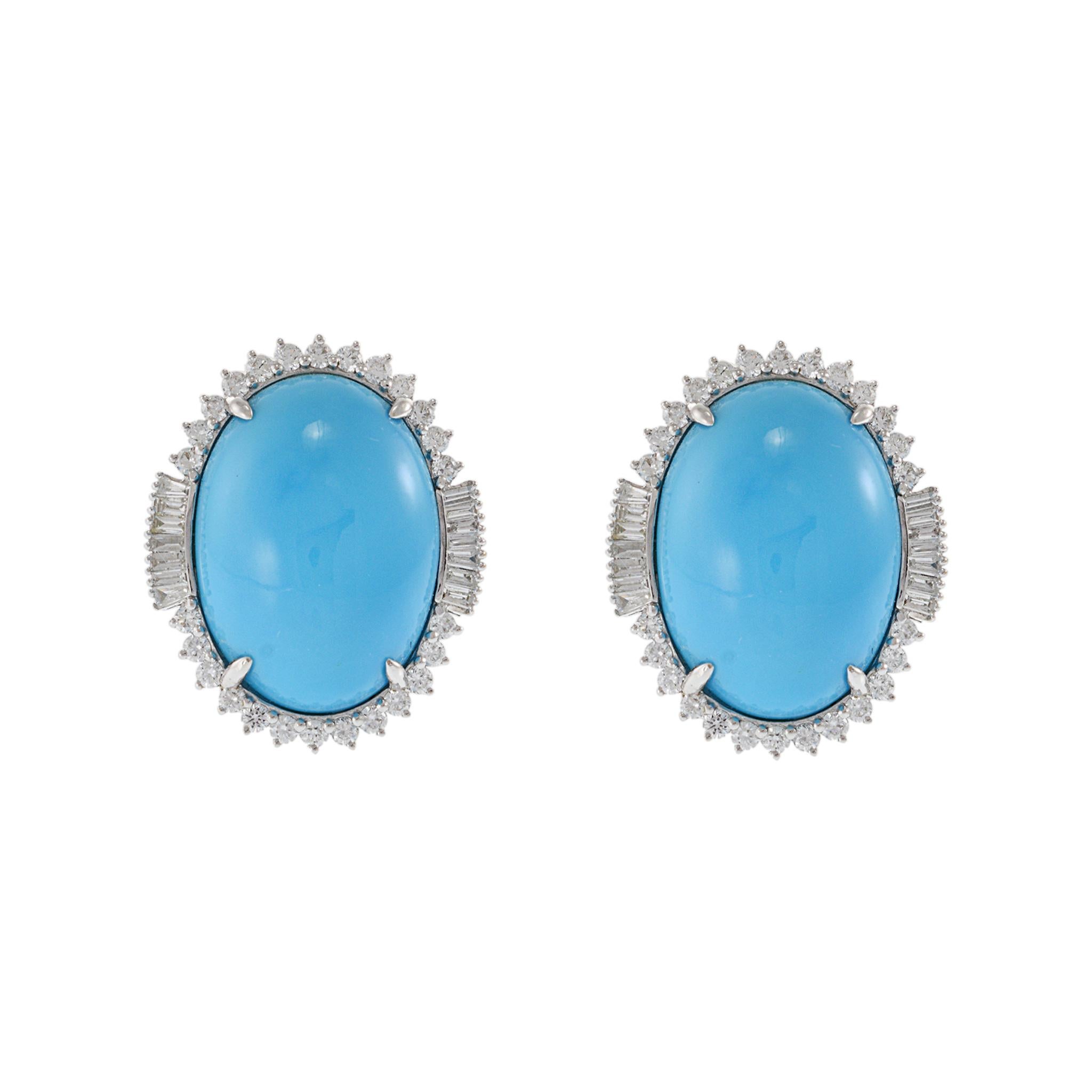 18KT White Gold Earrings with Natural Turquoise Surrounded by Round and Baguette Cut Diamonds. These sophisticated earrings showcase vibrant natural turquoise centers, elegantly encircled by 0.71 carats of sparkling diamonds in both round and
