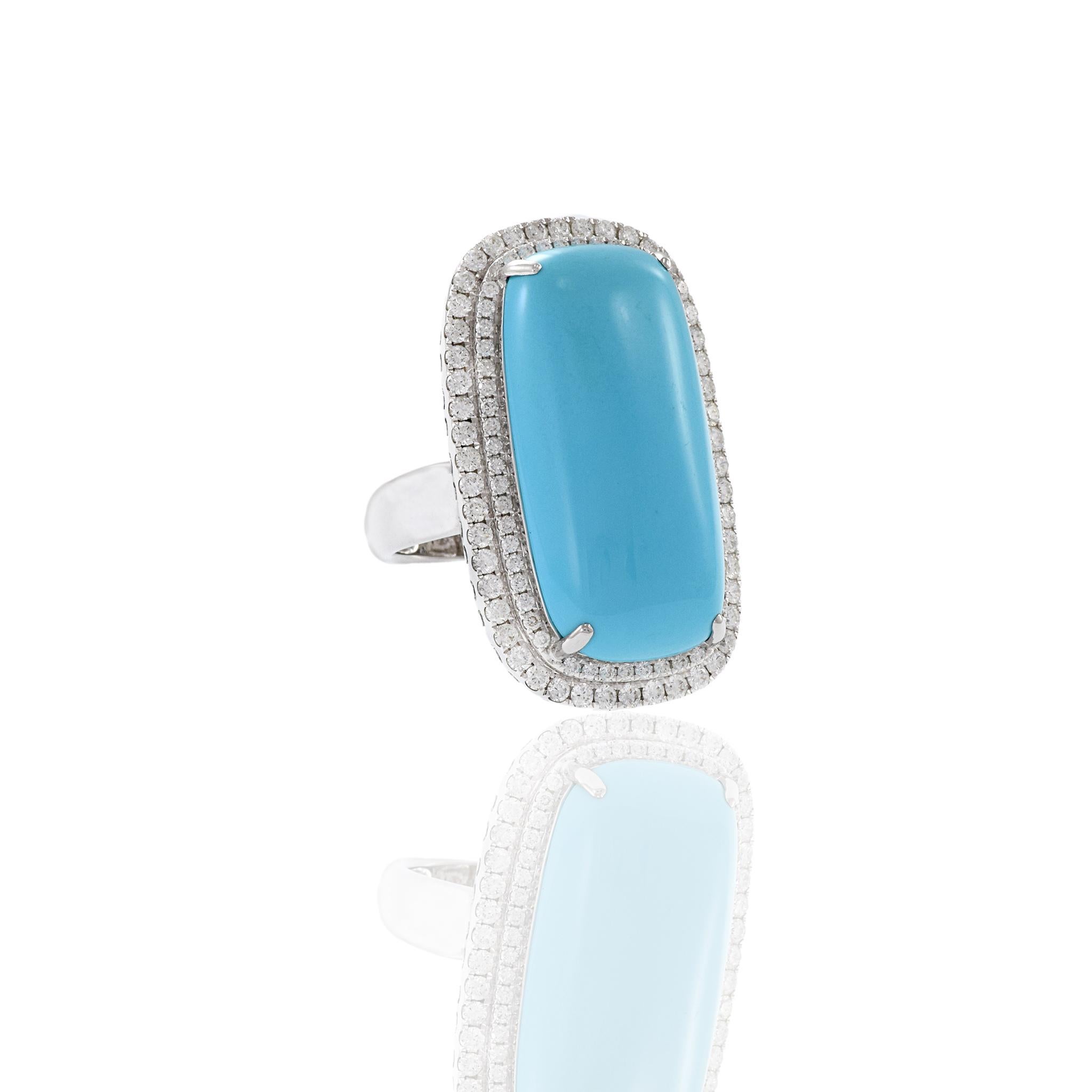 18KT white gold ring starring one oblong genuine Turquoise center stone surrounded by a double row of G-VS round cut diamonds weighing 1.74CT-TW. A timeless design crafted with only the finest materials for a one-of-a-kind piece that will stand out