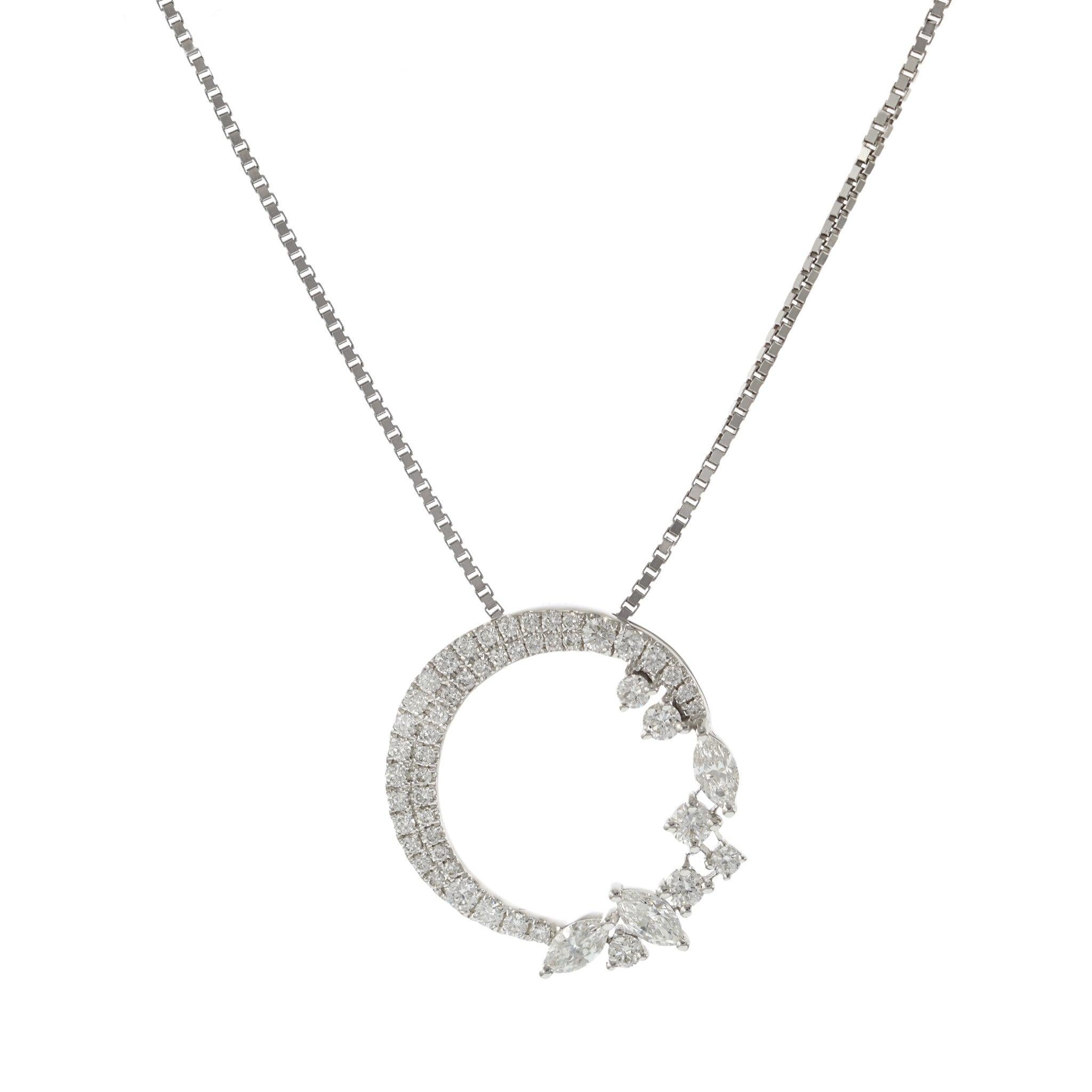 This stunning pendant features an open circle design, crafted in 18KT white gold. It is adorned with 0.59 carats of fancy diamonds, including both marquise and round cuts, with G color and VS clarity. The unique combination of diamond shapes adds an