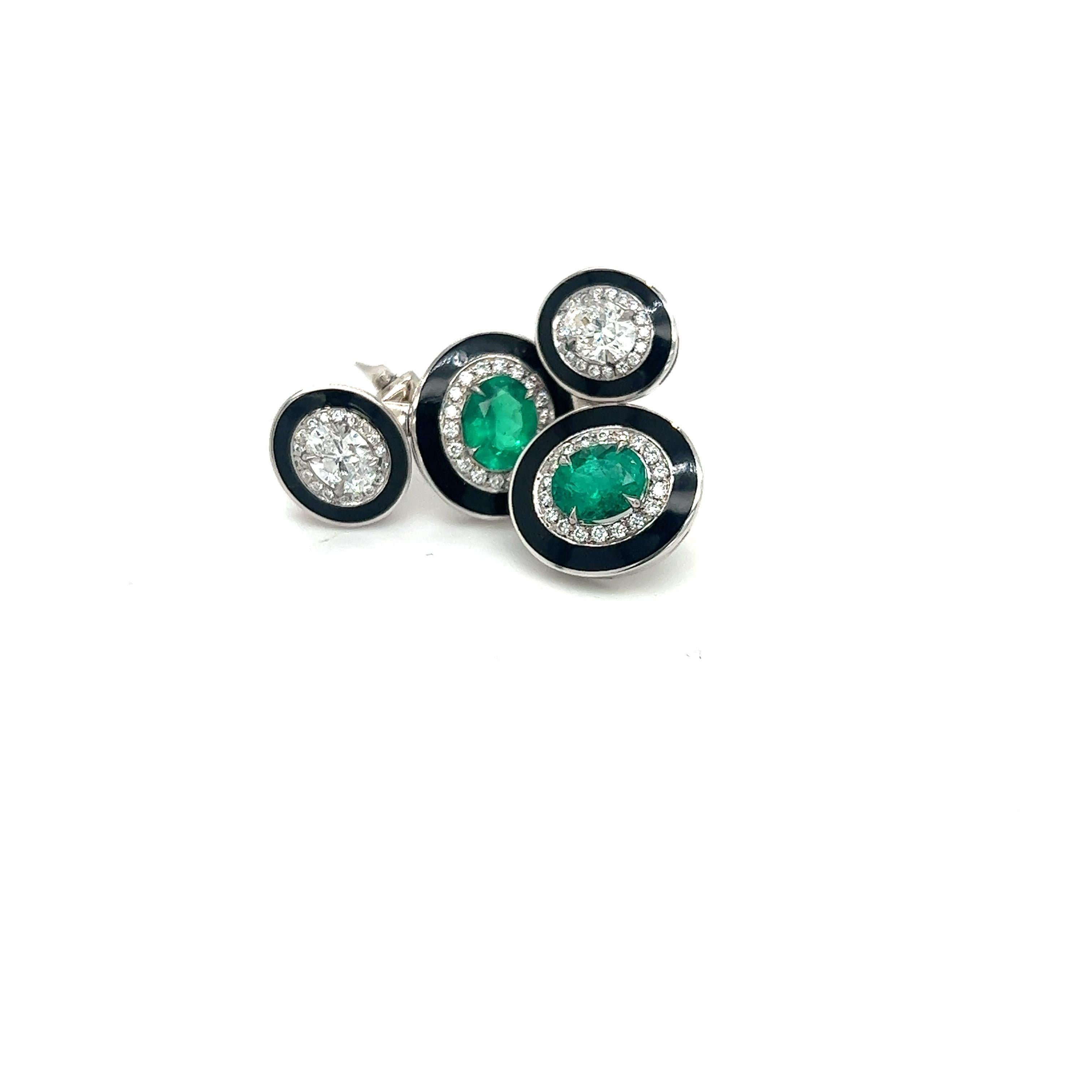 Art Deco inspired  18 karat white gold earrings, beautifully crafted with round brilliant diamonds and oval emeralds. Each center stone is bordered with  pave diamonds and black enamel. The earrings are pierced with a post and french clip which can