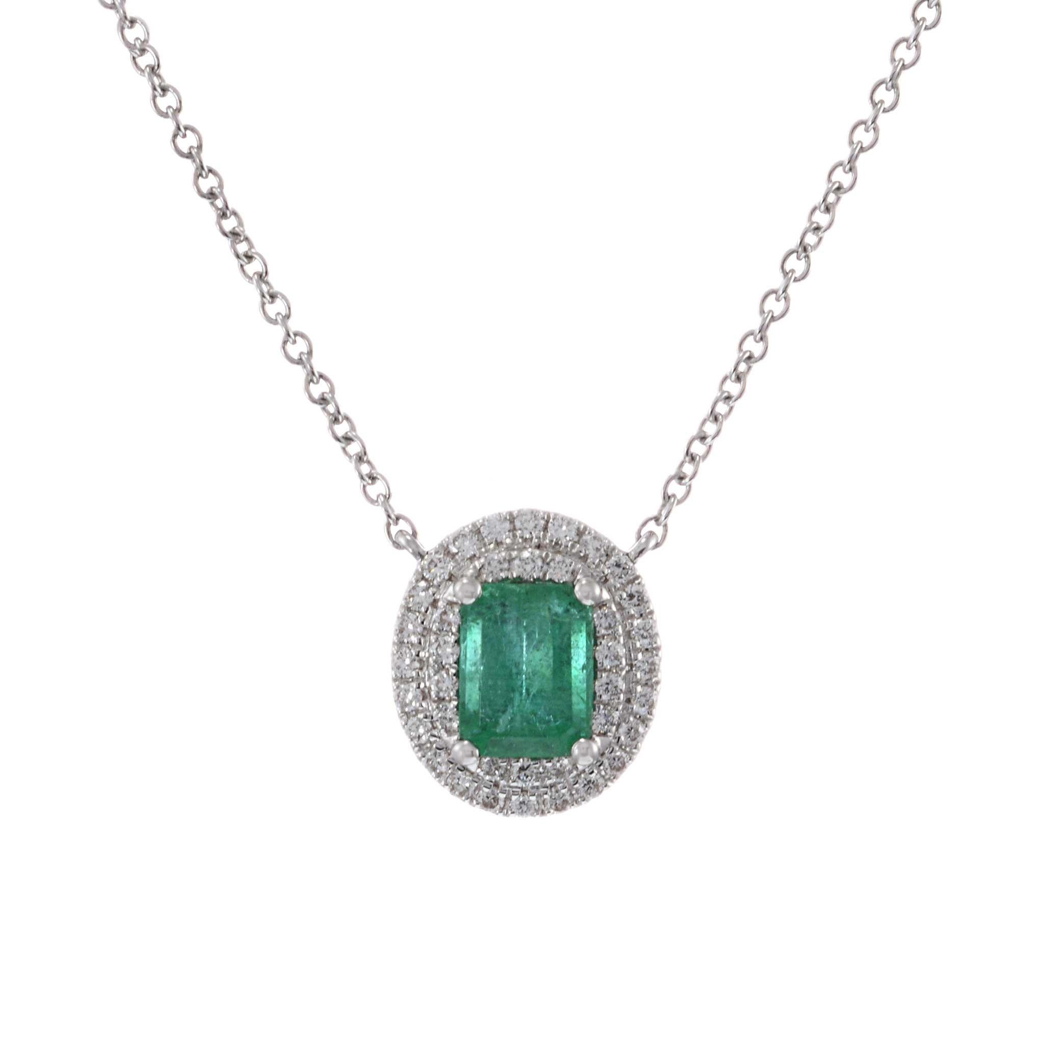 This elegant pendant features a 0.63 carat oval cut emerald, beautifully set in 18KT white gold. The pendant is accented with 0.28 carats of round cut diamonds, adding a touch of sparkle and sophistication. The combination of the vibrant emerald and