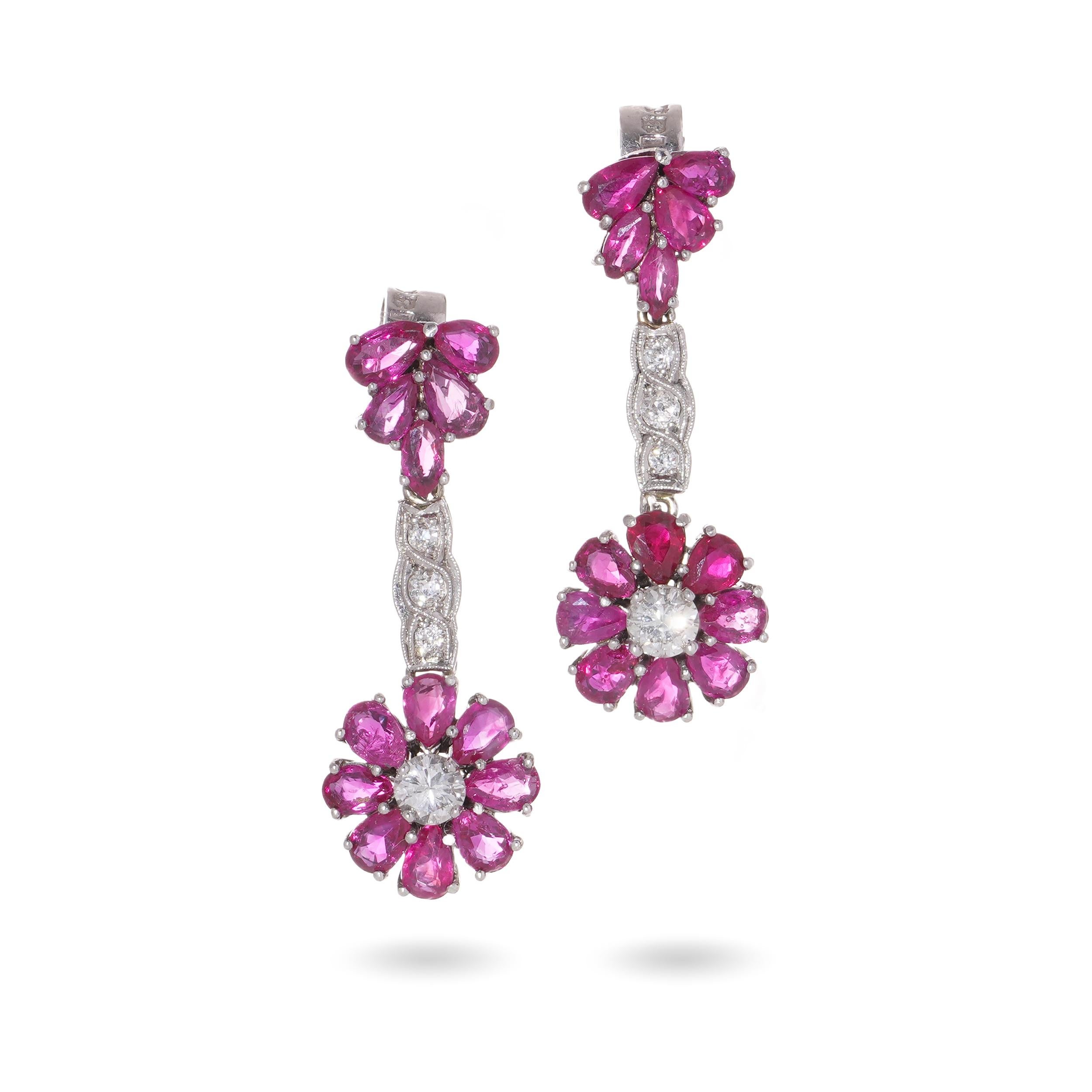 Vintage 18kt. white gold pair of drop earrings set with 0.54 carats of round brilliant diamonds and 2.60 carats of pear - cut rubies.
Hallmarked for 18kt. gold.

Item specifics:
Dimensions:
Length: 3 cm
Width: 1 cm
Weight: 8.00 grams in