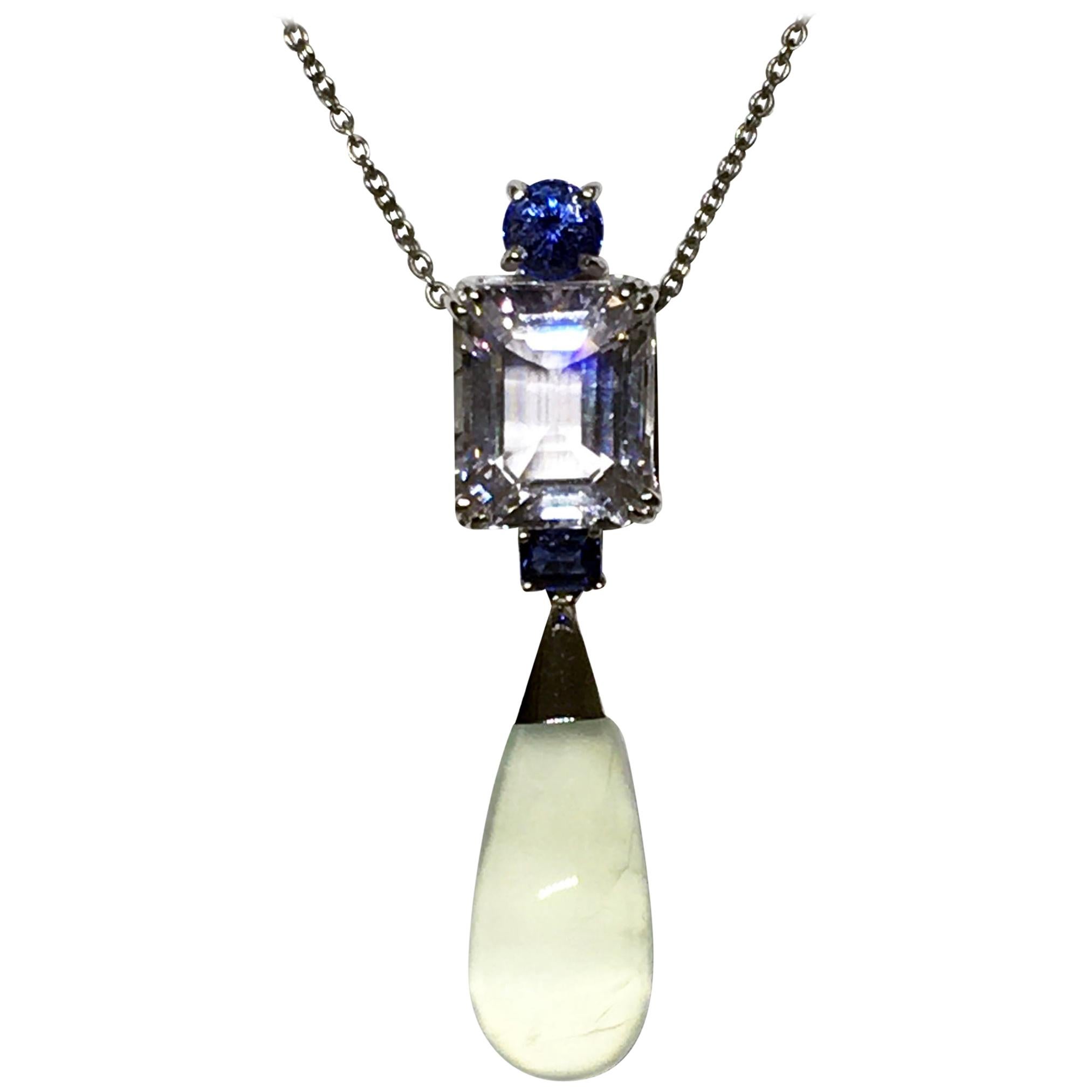 A Morganite, Sapphire and Prehnite Dangle Pendant set in 18kt White Gold. Set with One Small Round Blue Sapphire and a Second Emerald Cut Blue Sapphire Totaling 0.47 Carats. Also Set with an Emerald cut Morganite of 6.7 Carats & a 9.2 Carat Prehnite