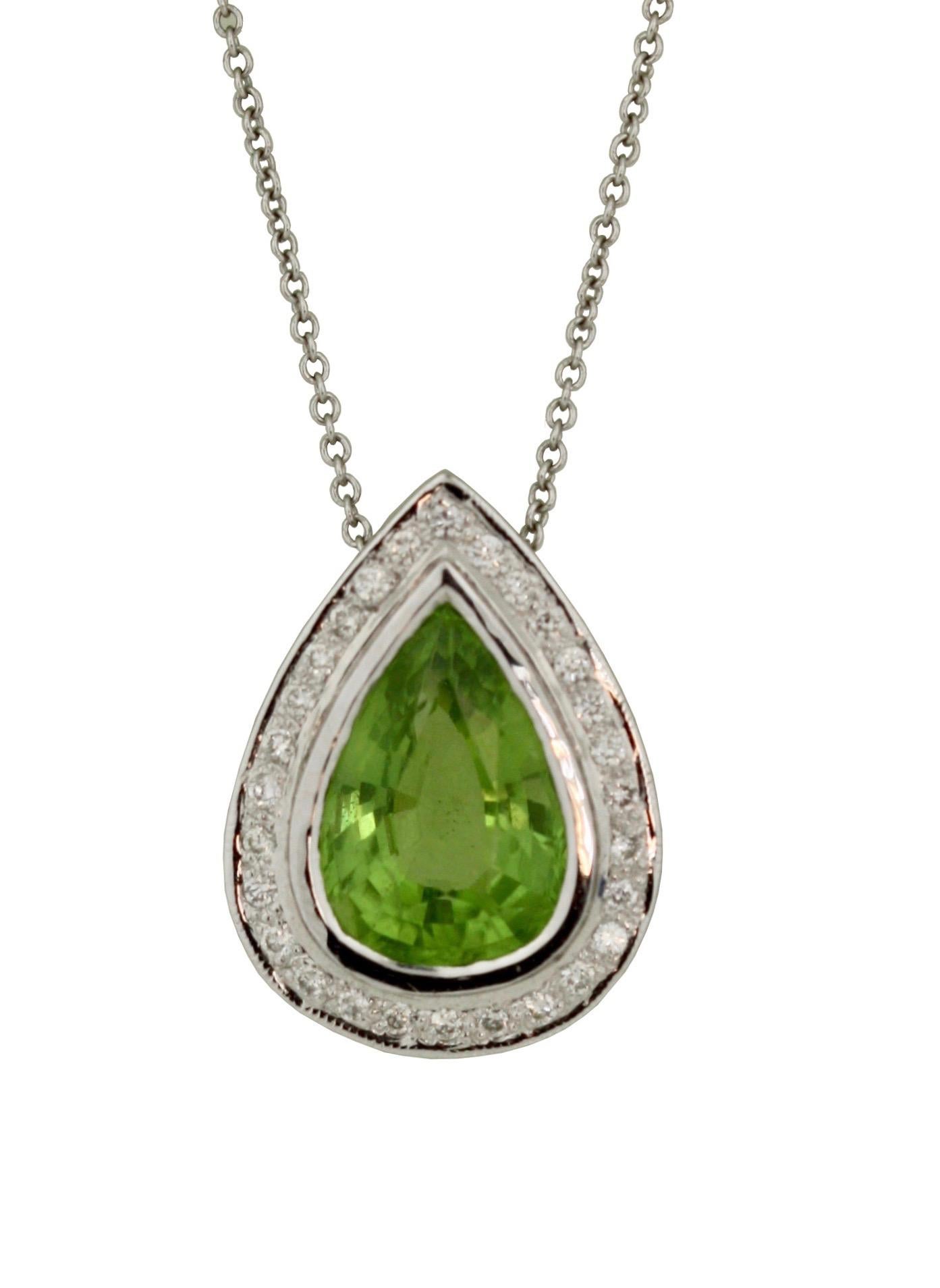 18kt White Gold Peridot and Diamond Pendant, 
Centered with a pear shaped step-cut peridot surrounded by diamonds, together with a 14kt white gold sixteen inch chain,
Peridot approx. 3.10 cts, Diamonds approx .50 cts
5.7 grams (gross).