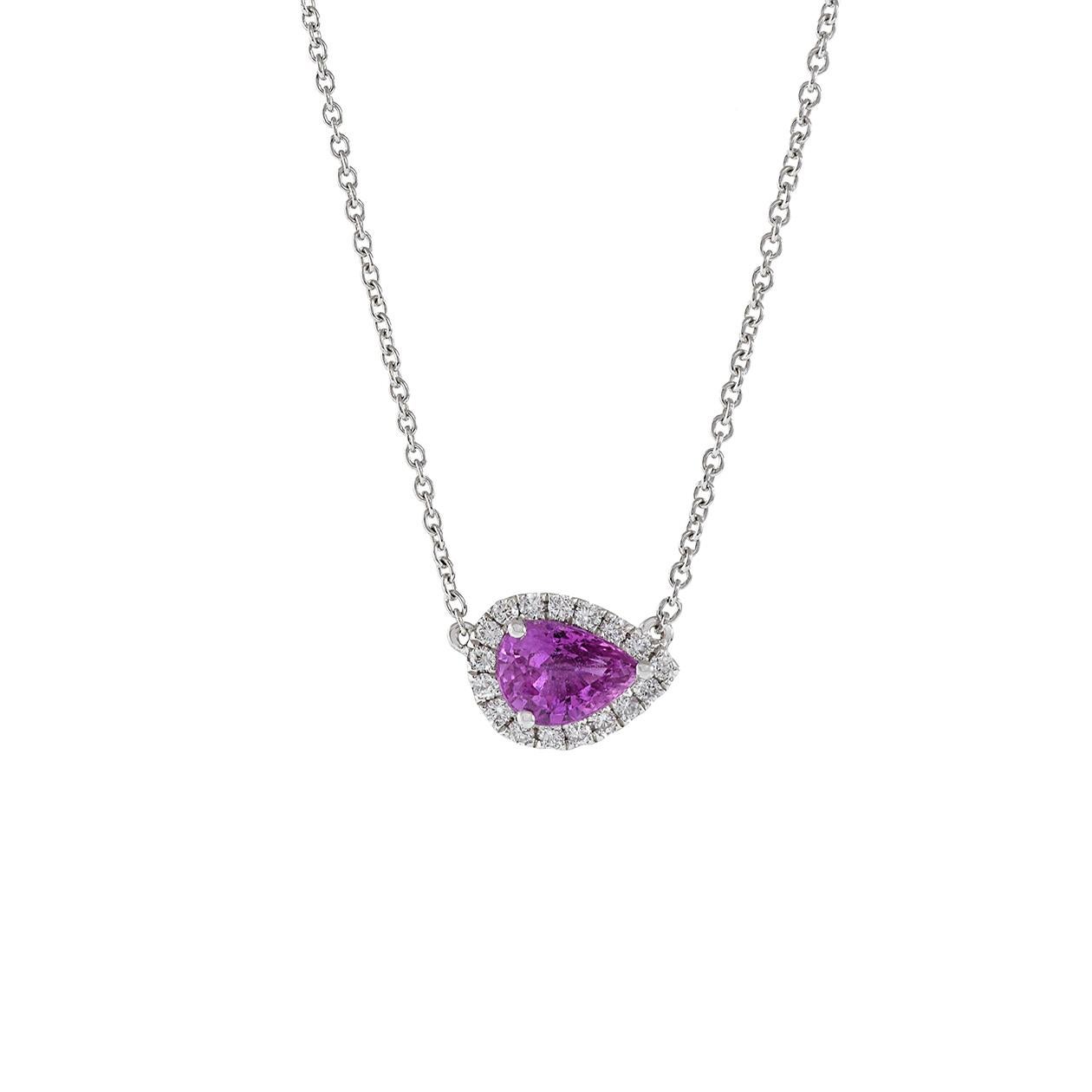 This 18kt white gold pendant necklace is a captivating piece of jewelry, featuring a genuine pear-cut pink sapphire with a weight of 0.82 carats. The unique orientation of the sapphire, set in an east-to-west direction, adds a modern twist to the
