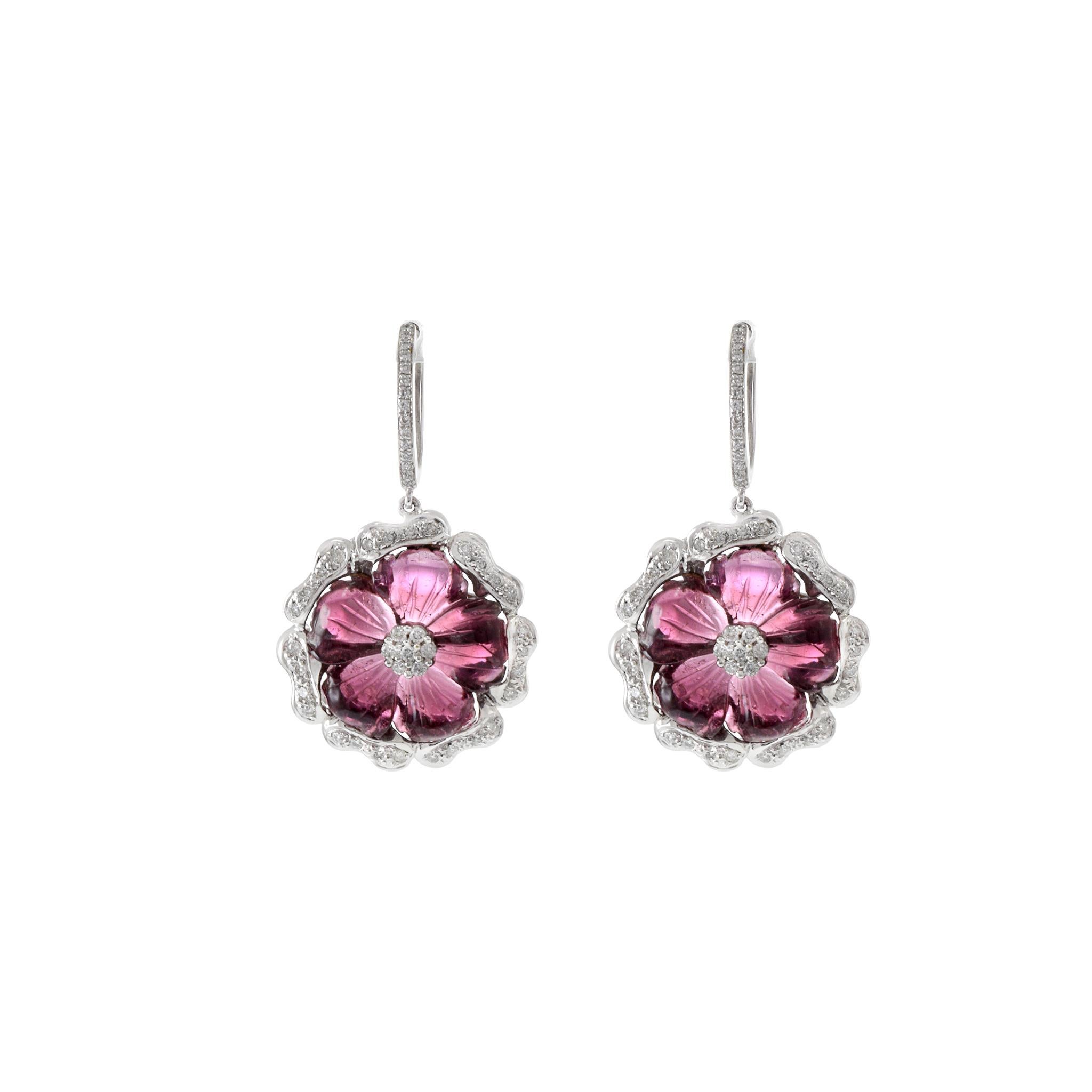 These exquisite 18KT white gold flower drop earrings showcase 15.80 carats of hand-cut flower petal pink tourmalines, surrounded by 1.00 carat total weight of G color and VS clarity round-cut diamonds. The combination of the soft pink hues of the