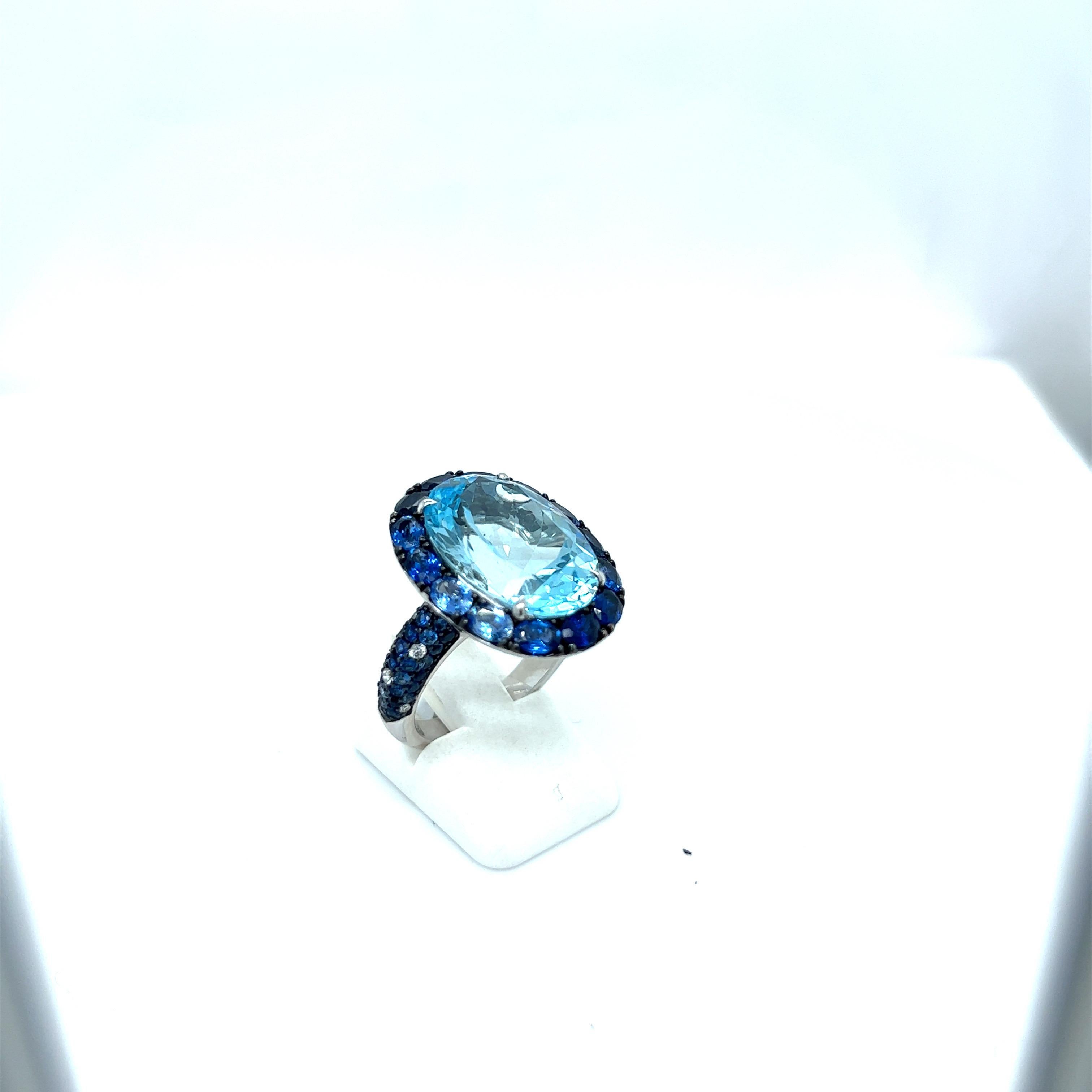 Oval Cut 18kt White Gold Ring 13.46ct Bluetopaz, 3.51ct. Blue Sapphires, 0.14ct Diamond For Sale