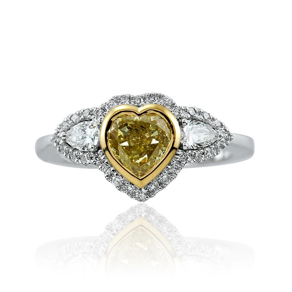 Amongst the rarest, this pretty 18kt white gold ring has a heart shaped GIA certified fancy yellow diamond with pear shaped diamonds on the shoulders totalling 0.23ct and round cut diamonds totalling 0.17ct.