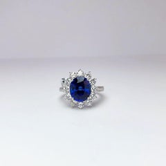 18 Karat Gold Ring with 5.12 Carat Oval Blue Sapphire with 1.27 Carat Diamonds