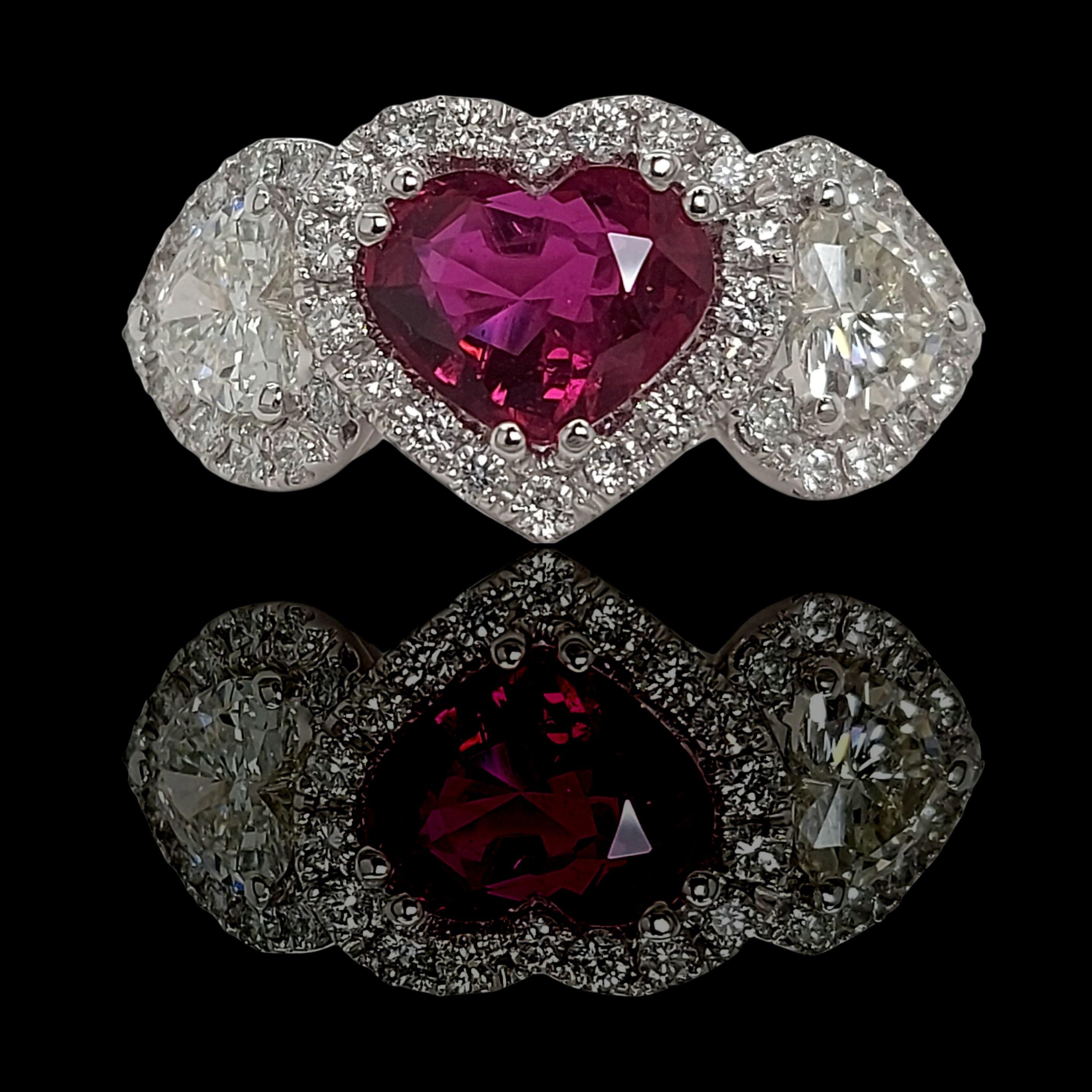 18kt White Gold Ring With Heart shaped Ruby and Diamonds

Ruby: Intense red Heart shaped Siam ruby 1.79ct

Diamonds: 2 heart shaped diamonds together 0.92ct and 42 brilliant cut diamonds together 0.76ct 

Material: 18kt White Gold

Ring size: 54.4