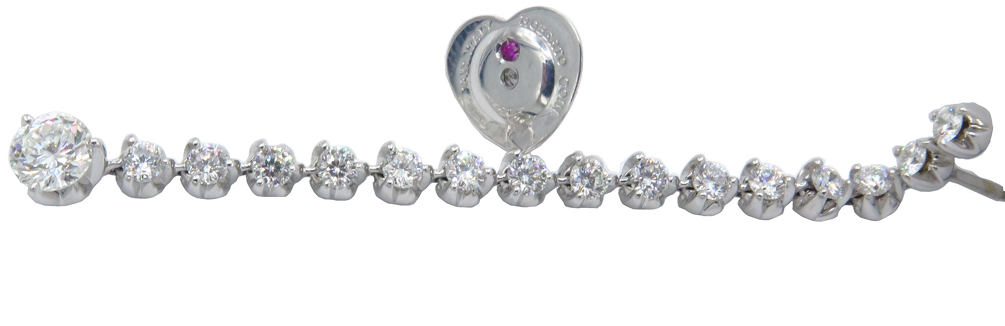 Beautiful, 18kt white gold Roberto Coin diamond strand earrings with 15 beautiful small round diamonds and a 0.5ct diamond at the bottom of the strand. Properly signed and hallmarked in the post clip by Roberto Coin signature ruby, there is also