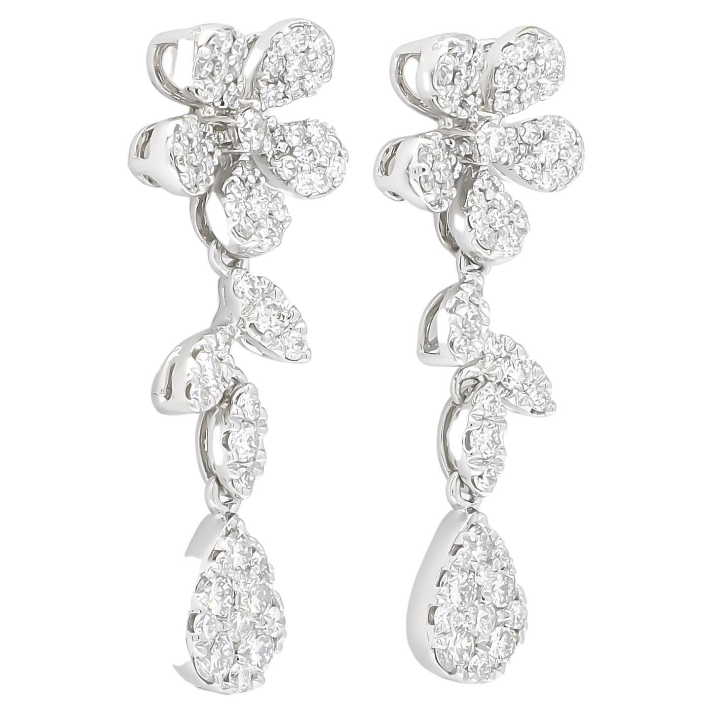 Get ready to embrace your inner flower power and shine with these sparkling round-shape diamond elongated cluster drop earrings set in 18k white gold. These earrings are the epitome of glamor, adorned with stunning flower and leaf-inspired diamond