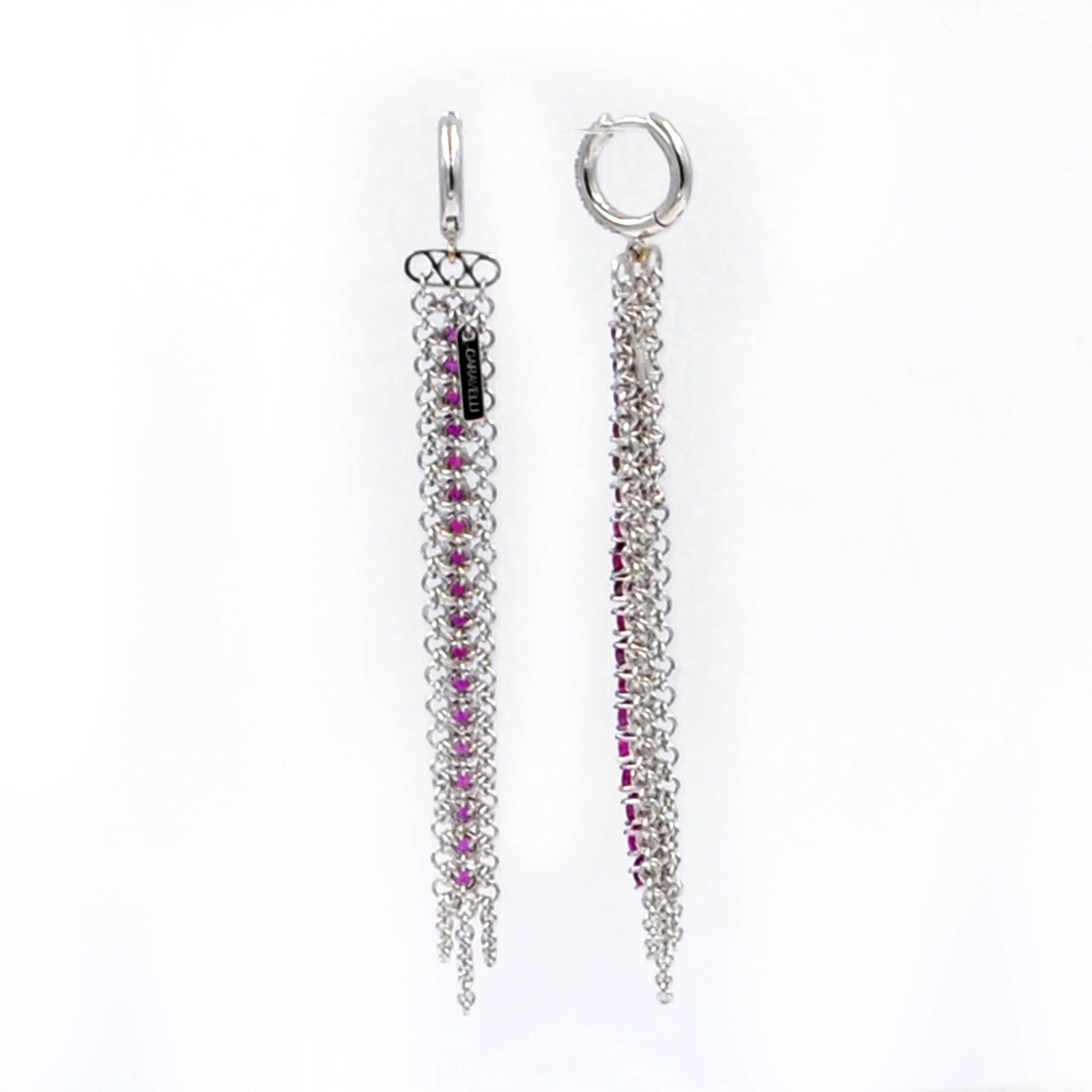 18KT White Gold RUBIES and DIAMONDS Garavelli Long Earrings. 
White pavè diamonds small huggies and a soft hand made gold mesh with a line of rubies, lenght 7.5 cm 
18 kt GOLD gr  : 11,84
WHITE DIAMONDS ct : 0,20
RUBIES ct  : 3,72
Matching pendant