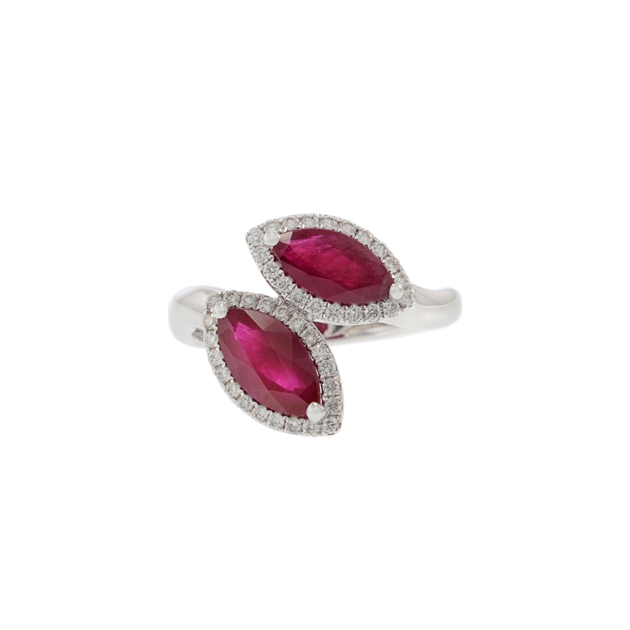 18KT White Gold Double Petal Ring with Round Cut Diamonds and Marquise Shaped Rubies. This exquisite ring features 2.56 carats of marquise shaped rubies, accented by 0.30 carats of round cut diamonds. Crafted from luxurious 18KT white gold, the