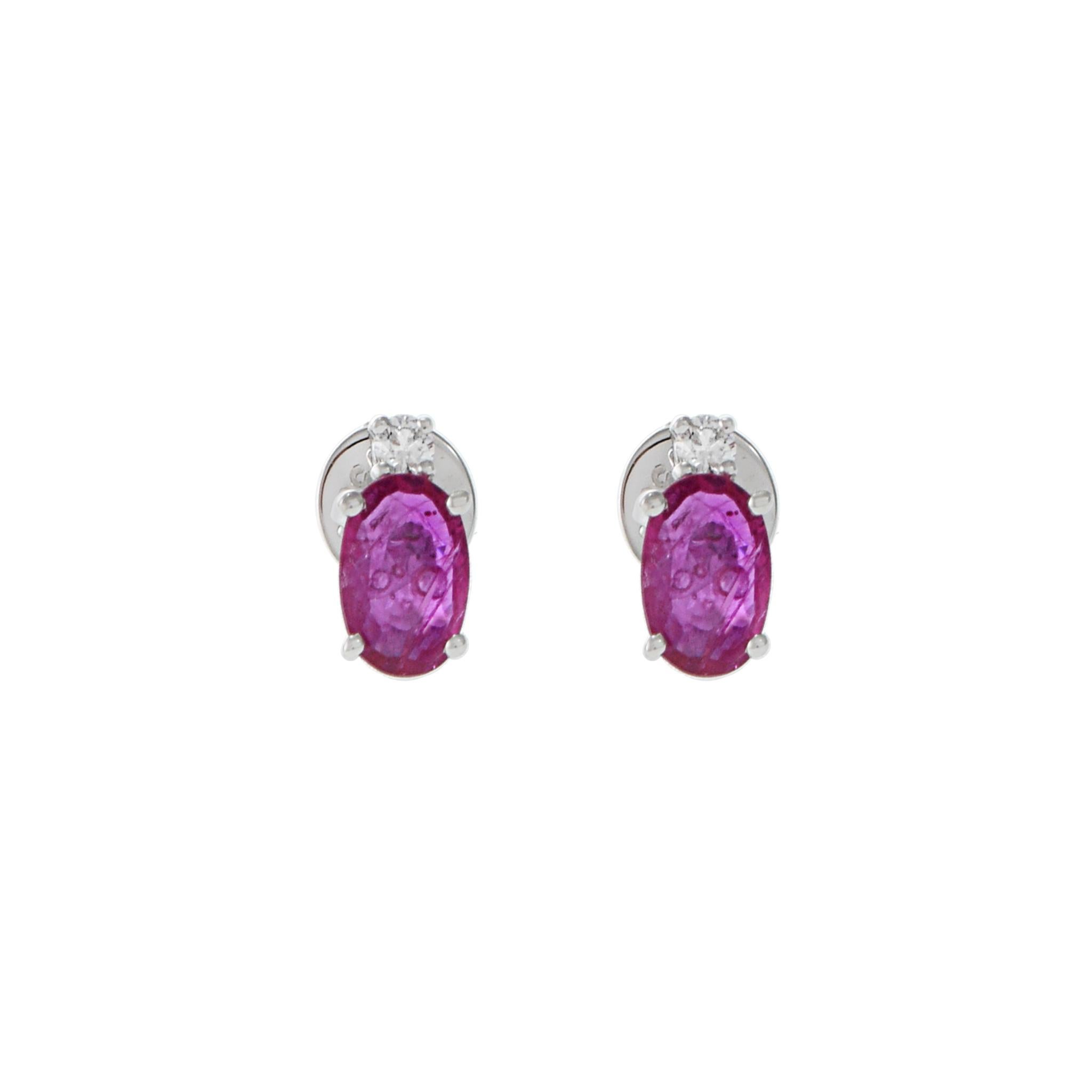 18KT white gold earrings consisting of 0.78CT-TW oval cut rubies and 0.05CT-TW round brilliant cut diamonds. Crafted with precision and care, these stunning earrings feature 0.78CT oval cut rubies and 0.05CT-TW round brilliant cut diamonds set in